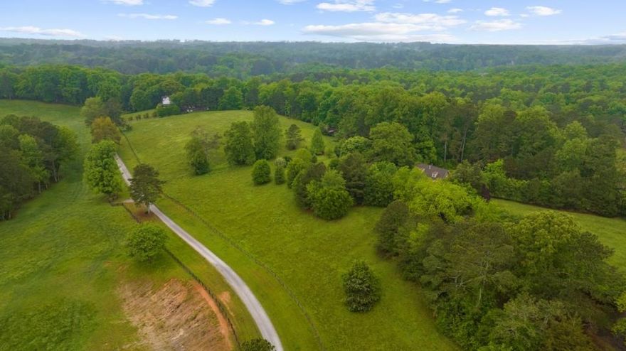 Rare opportunity to own 4.89 acres in sought-after Southeast Cherokee County with an Alpharetta address. This exceptional property sits atop a gently rolling hill and offers stunning panoramic views of the surrounding countryside. A mix of open pasture and mature hardwoods provides both beauty and versatility, creating the perfect canvas for your private estate. Whether you dream of building a peaceful retreat or developing a residence tailored to your lifestyle, this tract delivers endless potential   all just minutes from top-rated schools, shopping, and dining.