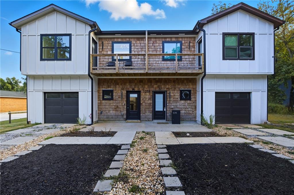 Step into contemporary sophistication at this new construction townhome in the heart of historic Oakland City. Built in 2023 and offering 2,160 square feet of living space, this one-of-a-kind residence combines decadent design, intentional comfort, and an elevated aesthetic. The home feels like a luxury retreat.
Inside, oak hardwood flooring flows through every room, grounding the home’s open layout. The great room is anchored by a sleek electric fireplace with custom built-in bookshelves, creating a striking focal point. The gourmet kitchen is well-appointed with a stunning Calacatta quartz waterfall island, white shaker cabinets, open shelving, pantries with sliding barn doors, geometric porcelain tile backsplash, black stainless steel Samsung appliances, and brushed brass fixtures. Floating stairs with dramatic floor-to-ceiling custom iron balusters in brushed brass and oak hardwood stair treads enhance the home’s airy and sublime atmosphere. Upstairs, discover three spacious bedrooms with generous walk-in closets. Each spa bathroom blends bold contemporary design with refined elegance, featuring frameless glass showers, custom tilework, and luxurious natural materials. The primary ensuite bathroom boasts a wagon wheel chandelier, a freestanding soaking tub, and an oversize tile shower designed for ultimate relaxation and rejuvenation.
Beyond the home itself, Oakland City is poised for remarkable transformation and growth with several revitalization projects nearby, including the redevelopment of Murphy Crossing, Oakland Exchange, One West End, The Met Atlanta, and Centennial Yards. Walk to the Westside Trail of the Atlanta BeltLine and Lee + White where you can find a curated collection of local restaurants, coffee shops, breweries, and a climbing gym. Quick access to MARTA, downtown Atlanta, and Hartsfield-Jackson International Airport present effortless convenience.
1278 Plaza is a lifestyle rooted in modern luxury and connected to the future of one of Atlanta’s most dynamic neighborhoods.