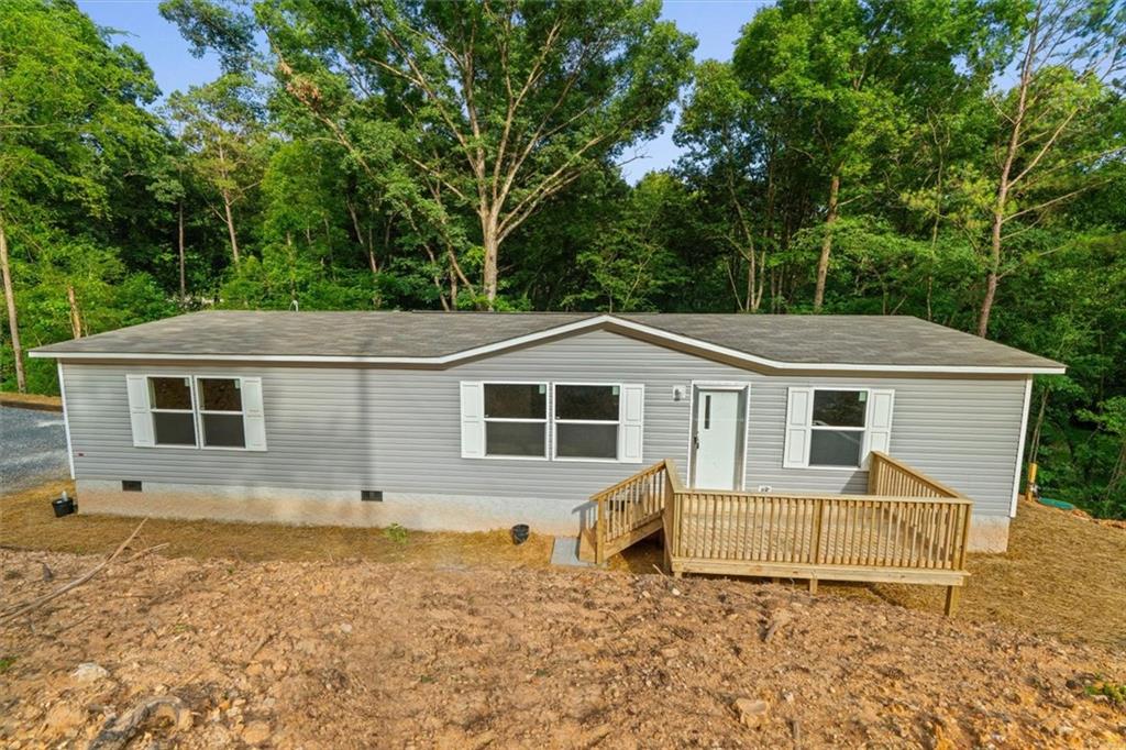 Brand new 3 bed, 2 bath double wide home offering modern comfort and style! Enjoy peace of mind with a 1-year manufacturer warranty and limited warranties on all appliances. The open-concept layout, upgraded kitchen, and natural light throughout make this home move-in ready. While the lot is sloped, it provides privacy and a scenic setting surrounded by trees—perfect for those seeking a tucked-away feel. Don’t miss this affordable opportunity to own a new home with long-term protection included! Agents read private remarks. Explore Seller-Financing options!