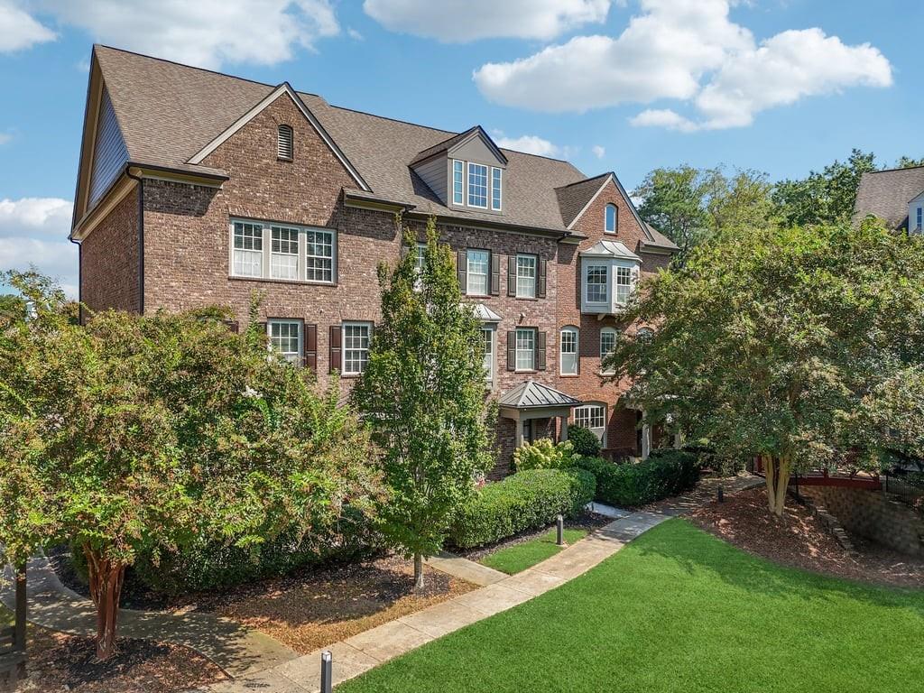 Tucked behind the beautifully manicured gates of Concord Hall, one of Smyrna’s most cherished and impeccably maintained communities, this stunning end-unit townhome at 550 Micayne Circle offers a lifestyle as elevated as its John Wieland-inspired architecture. With timeless brick on all four sides and a prime corner position, this residence exudes charm from the moment you arrive, facing an enchanting courtyard that feels plucked from the pages of a fairytale.
Step through the private front entry into a world where natural light dances across rich hardwood floors and crown molding, highlighting the craftsmanship and elegance that define this home. The main living space flows effortlessly with a modern open layout, anchored by a striking gas fireplace in the great room. Just beyond, the chef’s kitchen awaits, appointed with granite countertops, custom cabinetry, a walk-in pantry, and a generous island that invites both culinary creativity and social gatherings. Adjacent, the separate dining room easily seats twelve or more, creating a perfect setting for intimate dinners or holiday feasts.
Upstairs, the primary suite is a true sanctuary. A cozy bay window fills the room with morning light, while the spa-inspired ensuite offers dual vanities, a soaking tub, and a spacious walk-in closet. Two additional bedrooms, including a flexible terrace-level suite with full bath and private entry, offer space for guests, a home office, or even a fourth bedroom.
Enjoy your morning coffee or an evening glass of wine on the front porch overlooking the lushly landscaped courtyard, or step out to explore the vibrant lifestyle that makes Concord Hall so desirable. Less than 10 minutes away, the Atlanta Battery and Truist Park serve as hubs of entertainment, dining, and nightlife, perfect for Braves fans and city explorers alike. The Silver Comet Trail invites morning jogs or weekend bike rides through scenic Georgia woodlands, while the beloved Smyrna Market Village provides an irresistible array of boutiques, eateries, and community events year-round.
This townhome isn’t just about elegant living, it’s about connection. The Concord Hall community is tight-knit and prideful, with neighbors who care and a setting that’s as serene as it is sociable. Tree-lined streets, charming green spaces, and easy access to I-285 and I-75 make commuting a breeze while preserving the peaceful ambiance of suburban life.
Crafted with the timeless quality and thoughtful details expected from a John Wieland home, and lovingly maintained as a true gem of the neighborhood, this is more than a residence, it’s a lifestyle statement. Welcome home to Concord Hall, where luxury meets location and community becomes family.