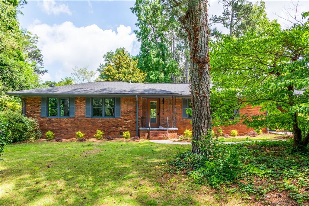 South West Atlanta Jewel! Welcome to this beautifully updated 3-bedroom, 2-bathroom brick ranch nestled on a spacious, tree-lined lot in Southwest Atlanta. With its classic curb appeal and fresh modern touches, this home is the perfect blend of timeless character and contemporary style. Step inside to find a light-filled living area with gleaming original hardwood floors, fresh paint, and stylish accents throughout. The updated kitchen opens to a large dining space and features sleek tile flooring, granite countertops, stainless steel appliances, and bar seating perfect for entertaining. Enjoy thoughtfully updated bathrooms, including a designer-tiled hall bath with modern fixtures and finishes. The layout flows seamlessly from room to room, offering both comfort and functionality. Outside, the lush front yard welcomes you home, while the private backyard offers plenty of room to relax or expand. **Location is everything **this home is situated within steps of West Manor Park, and just minutes from public transportation, restaurants, shopping, and local schools. With easy access to I-285 and all the conveniences of in-town living, this move-in-ready gem offers the best of both worlds.