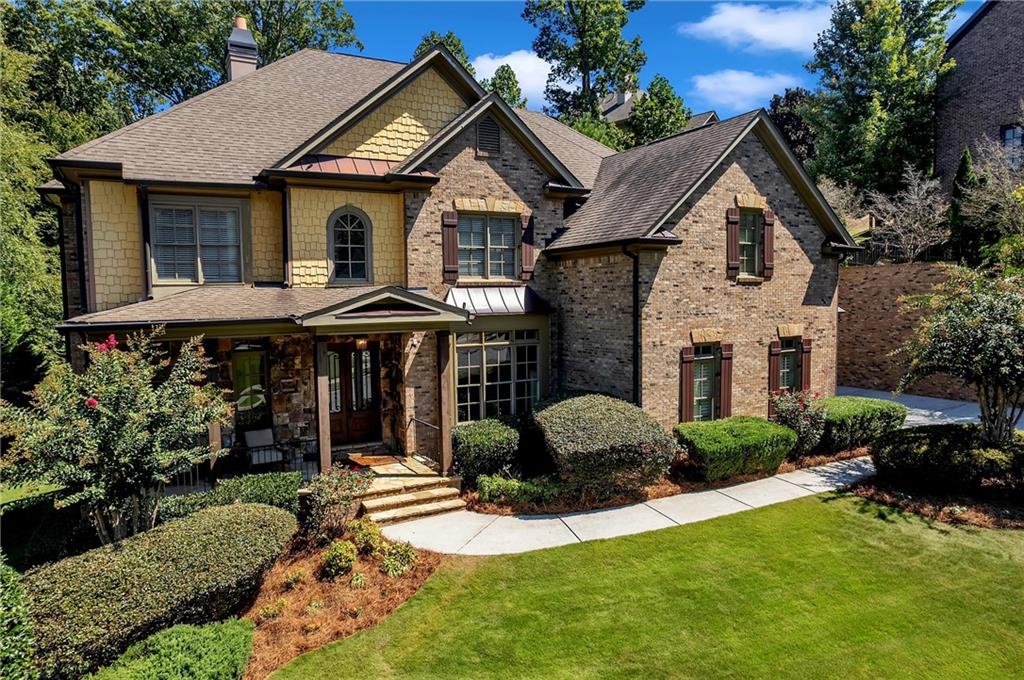 Formerly featured on HGTV, this extraordinary estate at 5709 Registry Oaks Lane is a masterful blend of designer luxury and inviting comfort. It's more than just a house; it's a showpiece where every detail has been thoughtfully curated to create an unparalleled living experience. Step inside and be captivated by the two-story foyer, where a glamorous designer chandelier casts a warm, welcoming glow. The grand entrance sets the tone for the entire home, leading you into a dramatic open floor plan with soaring ceilings and rich espresso hardwood floors. Exquisite custom details, including ten-inch baseboards, ornate crown molding, and sculpted door casings, flow seamlessly throughout the home, creating a sense of timeless elegance. Custom lighting fixtures, from sleek pendants to elegant chandeliers, have been meticulously selected to enhance every space. In the heart of the home is an expansive great room, with its 14-foot coffered ceilings and a breathtaking custom-cast stone fireplace that invites you to relax and unwind. The dining room, with its stunning wall of windows, is bathed in natural light, offering the perfect setting for both large-scale celebrations and quiet family dinners. A true culinary dream, the gourmet chef's kitchen features stunning Calcutta gold marble countertops, top-of-the-line appliances, and a massive central island-the perfect stage for both lively entertaining and cozy gatherings. The kitchen flows seamlessly into a comfortable keeping room, ensuring you're always connected to the conversation. The primary suite is a sanctuary of indulgence. It features a private sitting room with its own fireplace and an incredible custom closet designed to be a "California dream." The spa-inspired ensuite bath offers a serene escape, complete with an oversized premium tiled shower, promising relaxation at the end of a long day. In the study, custom built-in shelving provides both function and beauty, adding to the home's bespoke feel. This true 5-bedroom, 4-bath home offers endless possibilities for entertainment and recreation. The finished terrace level is a true haven, complete with a private movie theater, a dedicated exercise room, and a stylish wet bar. An added bedroom and full bathroom on this level provide the ultimate flexibility for guests. Upstairs, an elevated den and media room offer a perfect vantage point to take in the breathtaking views of the private, fully fenced backyard. Outdoors, your private oasis awaits. The meticulously maintained, lush green lawn provides a stunning backdrop for the built-in firepit, a charming HGTV-featured "she-shed," and a play area, all maintained by an automatic irrigation system. It's a perfect setting for al fresco dining, lively gatherings, or a quiet evening under the stars. The home also features a three-car garage with a charging station, offering ample space for vehicles and storage. Situated in a prime Mableton location, this home offers the best of both worlds: a secluded retreat with unparalleled convenience. It is just minutes from top-rated private schools like Whitfield Academy and SAE School, and offers easy access to the area's best shopping, dining, and parks. With downtown Atlanta just a short drive away, and Hartsfield-Jackson Airport roughly 20 minutes from your door, you're connected to everything you need while enjoying the privacy and tranquility of your own estate. This is your chance to own a home with genuine star power-a property that perfectly balances sophisticated design with the warmth of a family home. Don't miss the opportunity to live your dream. For more information call Patrick Walters 678-939-1941, ALICE OMOROGBE 404-375-7313