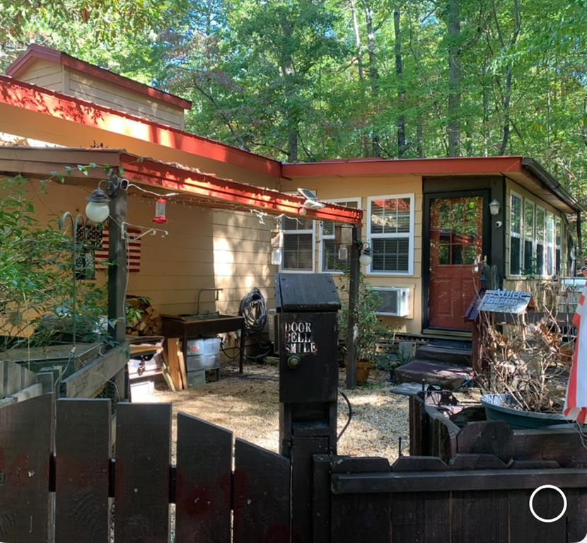 A place of peace by the stream sounds like an amazing spot to relax and unwind. Cabin has a touch of craftsmanship and a bit of country in every room.
Kitchen features a small pantry and ample cabinet space. A rocking chair by the fireplace would be a great place to read the winter evenings away. Firepit and
gathering spot outside are perfect for the cool evenings. Enclosed porch provides warmth on the cool mornings as you enjoy a bit of birdwatching and a hot cup of coffee. Bedrooms and sitting area on main floor are perfect for you and guests to gather before a great night's rest. Basement area features partial finished space and a nice spot for workshop including a full bath. The stream and the colorful fall leaves will remind you how easy it is to just be thankful for the natural beauty of North Georgia. Minutes from Carter's lake and great shopping in downtown Ellijay and just a few miles from the Apple house's and the Vineyard's.
Welcome to the "good life". Home was filled with love for many years and is ready for the next family to smile and say " home is where the heart is". It's so good to be home.