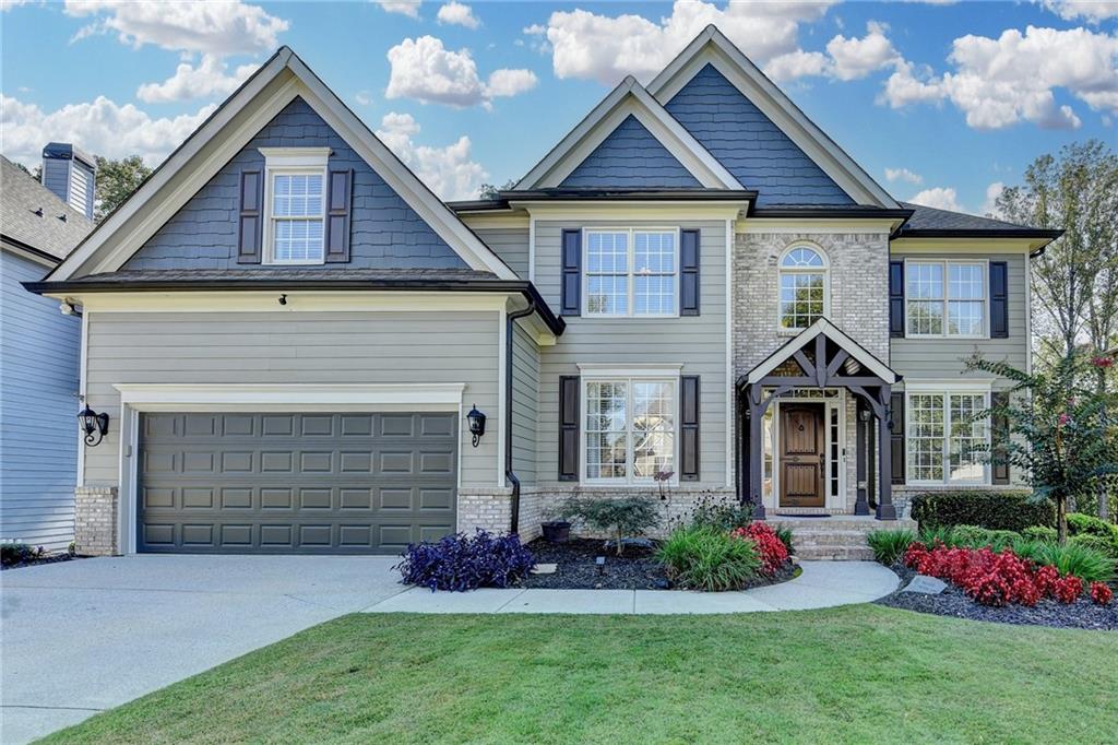 Welcome to this exceptional Home in the sought after swiim/tennis community of Daniel Park in Dacula. We are offering this 5 Bedroom / 5 Bath home on a full finished basement providing over 5,000 Sq Ft of beautifully designed living space* The main floor kitchen is outfitted with custom cabinetry, luxurious custom built stone-topped island, with second sink and disposal, microwave and plenty of storage*double ovens, pot filler*Coffee station at butlers pantry*A keeping room right off the kitchen adds even more flexibility and charm to the home's layout*Refinished hardwood floors on main* 2-story Family-room has custom built cabinets that flank the fire-place* Coffered ceiling in formal dining-room*In-law suite on main level*Tasting Lounge with double doors is designed to entertain your guests or you can curl-up to read a book, can't wait for you to see it* Upstairs has 4 bedrooms*New carpet in bedrooms* two with en-suites and one jack-n-jill to share. Upstairs the Primary suite is a true retreat, larger than most, it has a dedicated sitting area perfect for unwinding*The updated en-suite boasts a frameless glass shower, modern finishes, and a spa-like ambience*An Elevated terrace-level offers the perfect blend of entertainment and versatility featuring a spacious game room, a custom designed bar ideal for hosting and relaxing in style*A full size kitchen will meet your needs for extended stay or making snacks while you enjoy movie night*A dedicated office to work from home or a guest suite with full bath, ample storage*Step outside where meticulously maintained grounds provide a serene and elegant backdrop for outdoor living* Located in the top-rated Mill Creek High School district, this home delivers the perfect mix of modern comforts and timeless design, creating a lifestyle where elegance meets longevity.