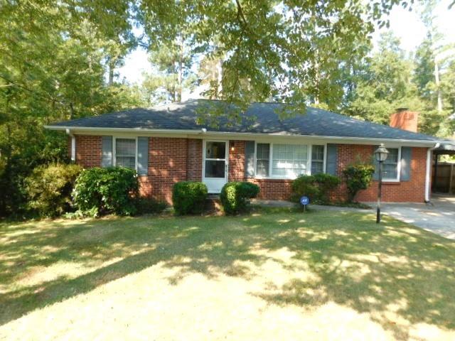 Spacious brick ranch with living/dining room open plan. Kitchen with lots of cabinets, Granite counters, all appliances (microwave, dishwasher, gas stove, refrigerator) and built-in panty. Two spare bedrooms with ceiling fans. Full hall bath with tiled tub/shower combination. Master bedroom with ceiling fan and attached half bath. Laundry nook with stackable washer & dryer included. This property has a bonus room with a decorative fireplace and access to the side covered carport and rear deck with table, four chairs and umbrella. Flat fenced backyard with storage shed. This property also have a lovely front yard. No carpet. Landscaping included in the rent. Parking on the driveway and covered carport. Convenient access to I-75, I-285 and 120 Loop. Close to Braves Stadium, Truist Park/ Dobbins AFB, Galleria and Cumberland areas. No aggressive dog breeds.