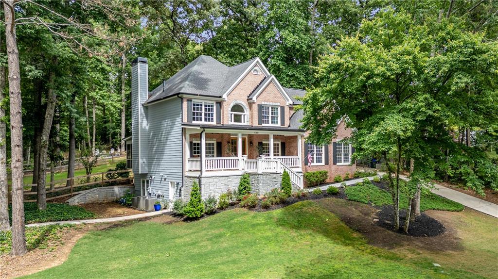 Welcome to this beautifully renovated custom home with NO HOA , perfectly situated on a sprawling one-acre lot with a partially fenced backyard—ideal for privacy, entertaining, and outdoor living. A charming wrap-around porch, accented by striking 9’ wood / beveled glass doors, sets the stage for the unique character and warmth found throughout the home.
Step inside to an open floor plan anchored by a dramatic two-story foyer, wrought iron balusters, and rich designer tile laid in a sophisticated herringbone pattern. The formal dining room boasts elegant wainscoting, while the formal living room provides a refined space for entertaining or relaxing.
The heart of the home is the gourmet kitchen featuring stainless steel GE appliances, granite countertops, and pendant lighting. It seamlessly opens to the spacious great room with a cozy fireplace and flows directly to the Double French doors open to a large screened in porch for year around enjoyment.
With five bedrooms and four full baths, this home offers ample space and flexibility. A bedroom on the main level adds convenience, while four additional bedrooms are located upstairs. Each bathroom is beautifully tiled and appointed with granite countertops. The luxurious primary bath includes a standalone soaking tub, a seamless glass shower, and thoughtful designer finishes.Enjoy even more living space in the full daylight basement with hardwood floors—perfect for a recreation room, home gym, or office. Outdoors, enjoy the best of country-style living with a workshop shed, a charming chicken coop, a garden area, and a custom-built firepit. Two driveways with extra parking make entertaining easy. With no HOA , this property offers the freedom to truly make it your own. A tankless water heater adds modern efficiency to this timelessly elegant home. Don’t miss the opportunity to own this one-of-a-kind retreat blending comfort, style, and flexibility. Only 10 minutes from Lake Lanier. Convenient to **Suwanee Town Center *Johns Creek ** City if Buford *City of Sugar Hill ** which hosts farmers markets, concerts, dining, festivals, and plenty of other community events. Nearby parks include ** Town Center on Main, DeLay Nature Park and PlayTown Suwanee, BIG SPLASH INTERACTIVE FOUNTAIN, Main Street park , SUWANEE CREEK GREENWAY , Sims Lake Park , George Pierce park , Suwanee Creek Park, Sugar Hill Greenway, E.E. Robinson Park .Walk to the city events on Whitehead Rd . Property line goes past the fence line .