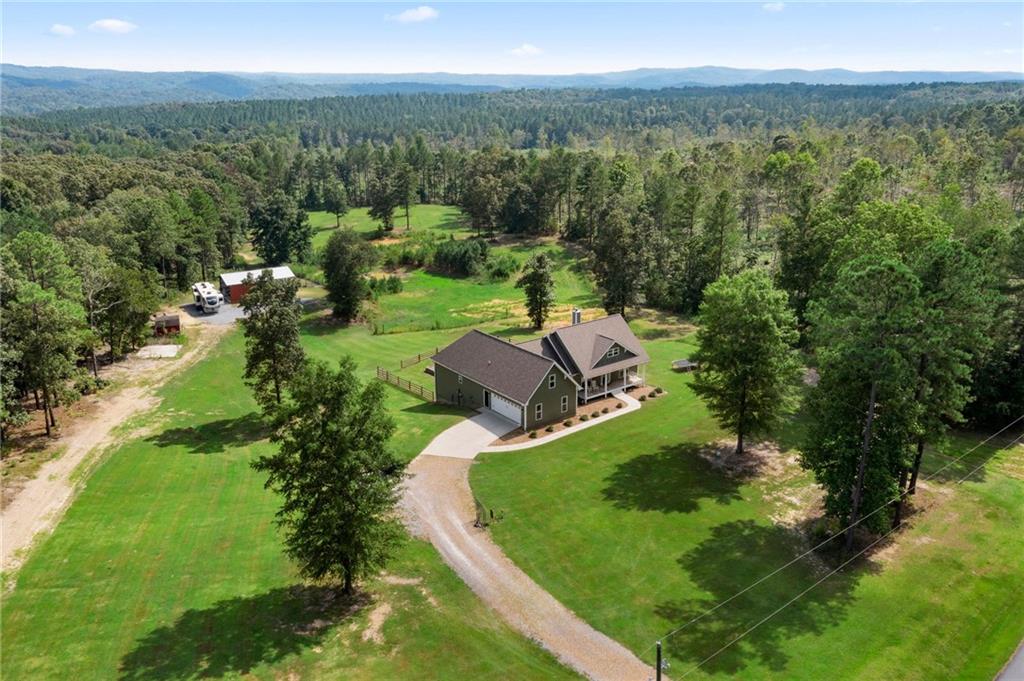 12.5 glorious acres on 2 tax parcels in the highly desired Morgan Valley area, this 3/3.5 home with a finished basement and potential for more is "The Elegance of an Estate. The Heart of a Home". Nestled on rolling acres, this estate captures the beauty of wide-open skies and the sophistication of modern design. Enter through the foyer into a sun-drenched great room anchored by a dramatic fireplace and southerly views of the rolling countryside. The formal dining room offers a spacious dining option for large families or entertaining. The chef's kitchen blends elegance with professional-grade function. The primary suite is a true retreat, vaulted ceilings, his and her sinks and offering a jetted tub, separate shower and dual walk-in closets. The rest of the family members are equally at home in their own ensuite quarters featuring 2 bedrooms and a Jack-n-Jill bathroom setup. Designed for gatherings, this lower level transforms every occasion into an experience. Venture to the basement where the home office, bar, and entertainment lounge make every day feel effortless. The open-concept lounge flows from a full wet bar with wood counters and a stove, sink and matching cabinetry to a spacious media area with theater-style seating and breathtaking views. Make the basement a full living quarter as an In-law suite or a teen's own private space with full bath, living room and kitchen area. Also, bring the toys! Plenty of storage and room for ATV's, mowers, tools and more through the basement access. Brand new, energy efficient HVAC unit just installed in 2024. Outside, the amenities await: a sparkling pool fenced with a covered patio to find a cool shade, for the grill or to have a cool drink by the pool and take in the breathtaking country side. Venture to the main level take in the pool view on the deck and watch the deer graze with your morning coffee looking over the pasture and pond or take in the sunset over the pasture after a long day. A custom barn for storage with power and water. Pasture area is partially fenced, bring the livestock or horses and have you own mini farm. Whether for equestrian pursuits, hosting unforgettable gatherings, or simply savoring quiet mornings, this property delivers a life of unmatched comfort and country charm. Homes like this do not hit the market often. Do not miss your opportunity to own this slice of heaven.