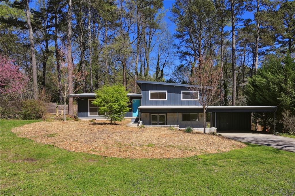Mid-century modern close to Pleasantdale Elementary School. Living room with vaulted wooden open-beamed ceiling and large picture windows overlooking front yard. Separate dining room that opens to a deck with pass through opening to kitchen. Older style kitchen with white wood cabinets, quartz countertops, electric cooktop and electric wall oven. Upstairs has 3 bedrooms (all with vaulted wooden ceilings - 2 corner bedrooms with 4 windows apiece), and 1.5 baths (the hall bathroom shares a walk-through shower with one of the bedrooms). Terrace level has a bedroom, bath, and cork floor den with a gas ball set fireplace w/gas starter and french door to front patio. Hardwood floors throughout. 2 car carport with storage closet. 1 dog permitted (small-medium) with a $500 nonrefundable pet fee (no violent breeds according to the CDC website). The application process involves checking credit and running national criminal background reports. This property will be available the first part of August. Please email all inquires and information requests to the agent.