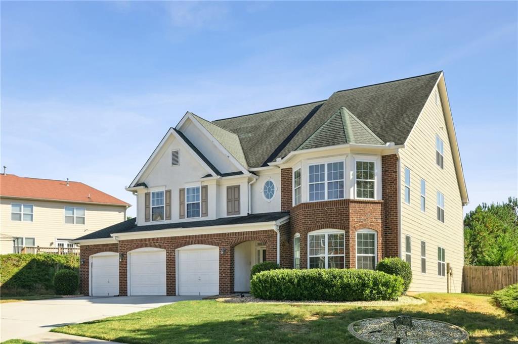 Welcome home to 520 Portico Court, a stunning three-story residence on slab that perfectly balances elegance, comfort, and functionality. This thoughtfully designed home offers seven bedrooms and four full bathrooms, ideal for multigenerational living or anyone seeking flexible space for modern lifestyles. First enter into a bright, two-story living room filled with natural light and an open layout perfect for entertaining or relaxing. The main level features a separate dining room, a spacious family room, and a large kitchen with a center island, granite countertops, and plenty of cabinet space. A bedroom and full bath on the main floor make this home ideal for guests or multigenerational living. Upstairs, the primary suite offers a peaceful retreat with a jacuzzi tub, double vanity, walk-in closet, and sitting area. The second floor also includes three additional bedrooms and a full bath. The third floor adds even more flexibility with a loft area, two spacious bedrooms, and a full bath perfect for a home office, media room, or guest suite. Outside, enjoy a large, flat, fenced-in backyard, ideal for entertaining, kids, or pets. The three-car garage provides ample space for vehicles, storage, or a workshop. Located in the amenity-rich Summit at Stonewall Tell community, residents enjoy swim and tennis facilities and a peaceful, well-kept neighborhood. Conveniently situated just minutes from Hartsfield-Jackson International Airport, Wolf Creek Amphitheater, and local shopping and dining. This home offers the perfect balance of comfort, convenience, and community. 520 Portico Court - where thoughtful design and everyday luxury come together beautifully. Don't miss your chance to call this beautiful home yours! Schedule a showing today!!!