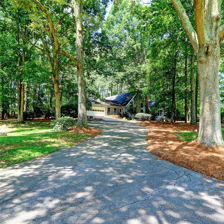 A Rare Slice of Country Living in Gwinnett – 7.88 Acres with Pool, Barn & Gated Entry - Welcome to 4393 Cannon Road—a one-of-a-kind estate offering the best of private, pastoral living just minutes from conveniences in Loganville and Grayson. Set on nearly 8 fully fenced acres, this 4-bedroom, 3-bath traditional home delivers a unique blend of comfort, functionality, and room to grow. The main level features a spacious primary suite with a luxurious bath including double vanities, heated floors, a soaking whirlpool tub, and separate shower. Vaulted ceilings and exposed beams enhance the oversized great room, while the kitchen offers solid-surface countertops, an island, pantry, and views to the living area—perfect for entertaining. A formal dining room, main-level laundry with sink, and multiple flexible-use rooms round out the thoughtful layout. Outdoors, the amenities shine: enjoy a private, resort-style gunite pool, open pasture views, and a multi-purpose barn with 4 stables(2 with infrared heat), a tack room with infrared heat and hot and cold water, storage galore, and a 2 John Deere tractors plus a bush hog included in the sale. A secure gated entrance offers peace of mind, and there's ample space for horses, gardening, or future expansion. Additional features include hardwood and/or tile floors, masonry fireplace with wood-burning stove, a 2-car garage, and high-speed internet availability—all on a level, tree-framed lot with fantastic road frontage. Whether you're seeking a hobby farm, family compound, or simply room to breathe, this property checks all the boxes.
