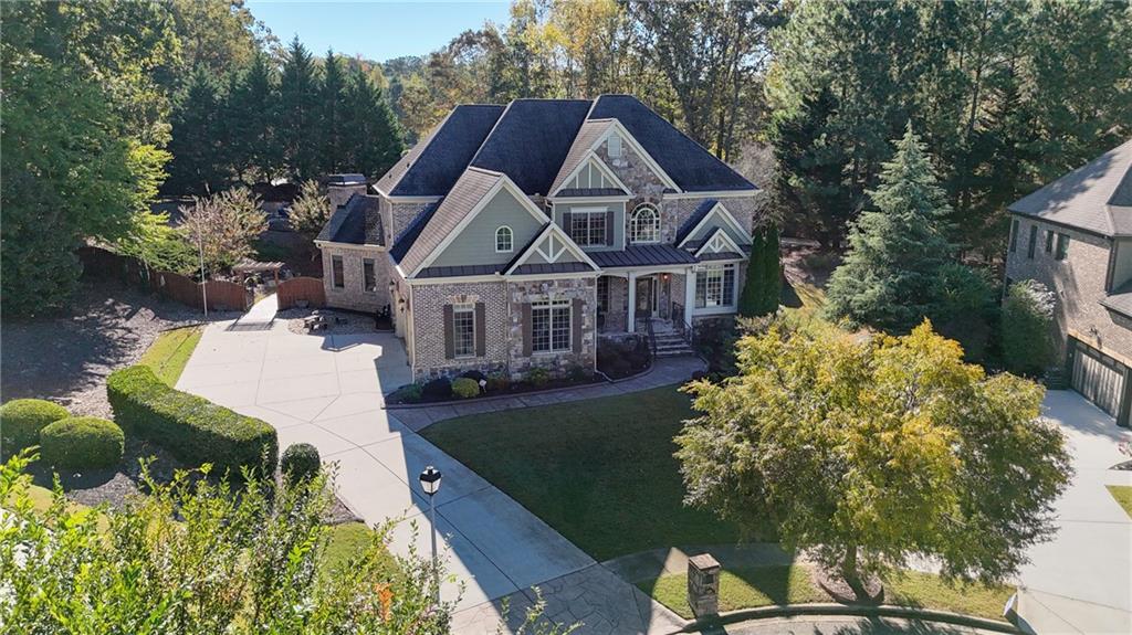 Welcome to your dream home in Hidden Falls! This beautiful 7BR/5BA retreat sits on a private cul-de-sac and offers the perfect blend of luxury, comfort, and lifestyle. Step inside soaring ceilings, elegant details, and open spaces made for gathering. The gourmet kitchen with Cambria countertops, stainless steel appliances, and keeping room fireplace is the heart of the home. Enjoy movie nights in the upstairs media room or unwind in the owner's suite with sitting area and double fireplace. The finished terrace level with full kitchen is ideal for guests or entertaining. Outside, relax on the screened porch or under the pergola while listening to the peaceful sounds of your 32-ft backyard waterfall. Hidden falls offers resort-style amenities-pool, tennis, clubhouse, fitness center, and playground-all close to top schools, shopping, and dining. A truly special place to call home.