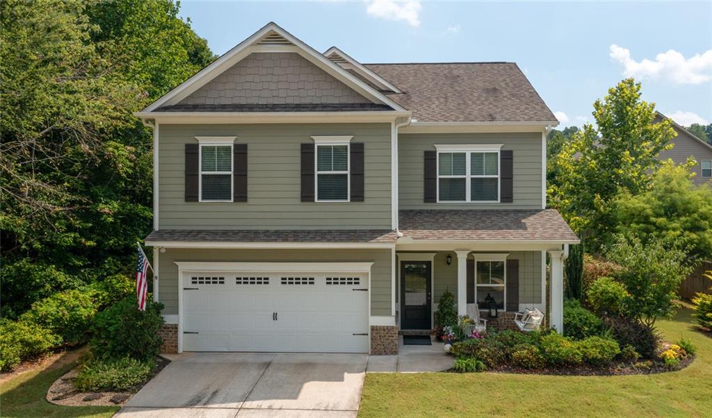 This beautiful home offers impressive curb appeal and a flowing open floor plan, perfect for both entertaining and everyday living. A welcoming foyer sets the stage for the spacious layout ahead. On the main level, enjoy a formal dining room, a bright family room with a cozy fireplace and a wall of windows that fill the space with natural light. Thoughtfully designed kitchen with tile backsplash, a generous eat-in bar, and a built-in desk area.The primary suite is a true retreat, featuring elegant tray ceilings and a spacious layout with a sitting area. The ensuite bathroom boasts a double vanity, separate tub and shower, and a large walk-in closet. Rounding out the upstairs are three roomy secondary bedrooms, a full bathroom, and a laundry room for added convenience. Step outside to the backyard sanctuary, where the breakfast room opens to a charming patio surrounded by lush landscaping. Stacked-stone flower beds, stepping-stone pathways, and a dedicated sitting area create a private courtyard feel, offering tranquility and natural beauty right at home.
