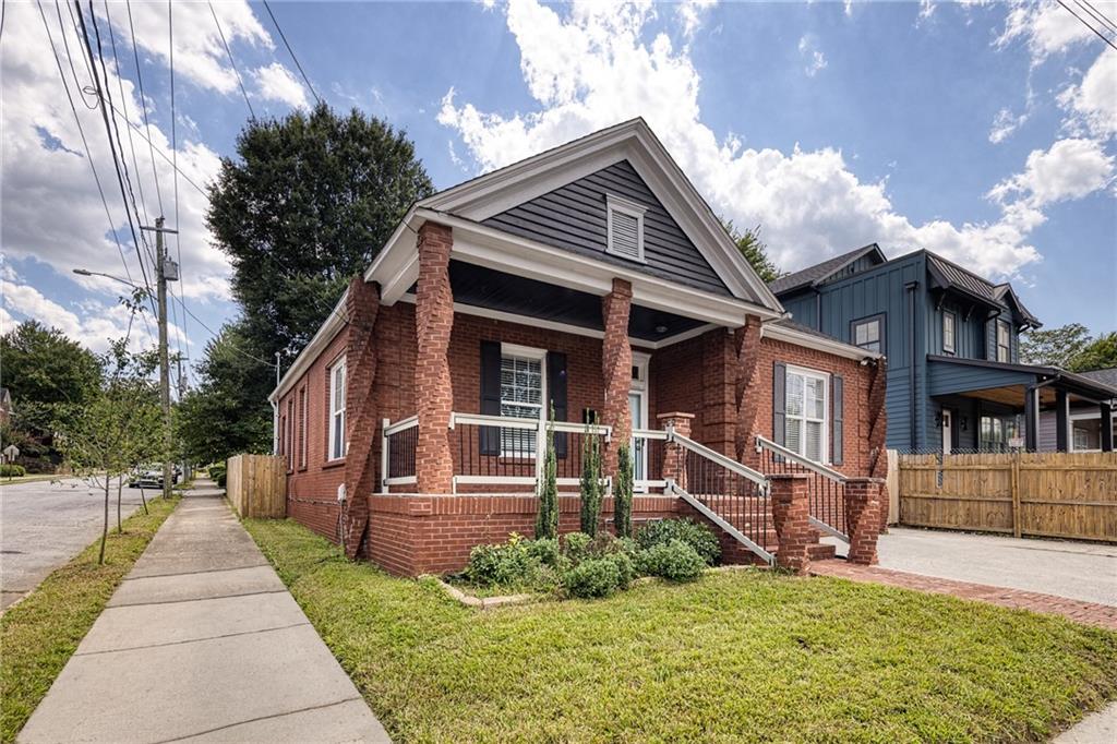 It’s a BOGO! Charming all-brick home featuring 3 bedrooms and 2 full bathrooms in the main residence and a bonus guest house/studio apartment ideal for Airbnb, long-term rental, home office, or creative space.
The main home boasts a brand-new kitchen with stainless steel appliances, shaker cabinetry, island, and pantry. Enjoy the open floor plan, high ceilings, living room with fireplace, and hardwood floors throughout. Private, fenced, level backyard on a corner lot.
Located in the fantastic Summerhill neighborhood, it’s just a short walk to the new Publix, fine dining, and the exciting Hank Aaron development with shops and restaurants