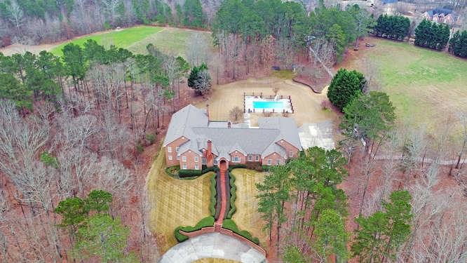 56+ beautiful private acreage w/lots of wildlife, 2 ponds, a 7 bdrm/9 bath home, 4 fireplaces, gunite pool, His & Her pool baths, 4 car garage, pasture & much more. You will be hard pressed to find a home & acreage like this. Spacious kitchen opens to a keeping rm, formal dining rm & brfk rm. Separate living rm, study & an amazing sun room that overlooks the yard. Lower level has a 2nd kitchen, family rm, game room, 4 bdrms & more. Plenty of room to park a boat or RV. Lots of options; use as your own private retreat, B&B or develop. View virtual tour for aerial shots Per Hall County - it is estimated that sewer will be available in this general area around the Spring of 2021.