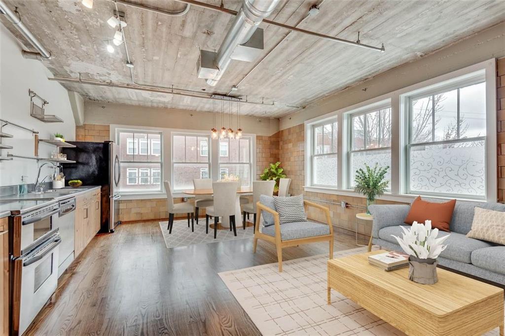 This rare corner unit at the historical Kingan & Co building in the heart of Castleberry Hill is truly one of a kind. The industrial chic style combined with tons of natural light and interesting original features comes together into a stunning city loft. This unit was an office for Kingan & Co, and the bathroom still uses an original bank safe door! Warm honey hardwood floors, open concept kitchen with stainless steel appliances, soaring ceilings, and 2 walls of huge windows. Unit includes 189 sqft of personal storage space in basement. Perks of the building include gated parking lot (1 space plus visitor spaces), fenced dog run, a cozy fitness center, and an incredible rooftop patio! Everything about this condo is an urbanites dream. Conveniently located near public transportation, No Mas! Cantina, Mercedes Benz Stadium, State Farm Arena, Centennial Park, and of course the Castleberry Hill Historic Arts District.