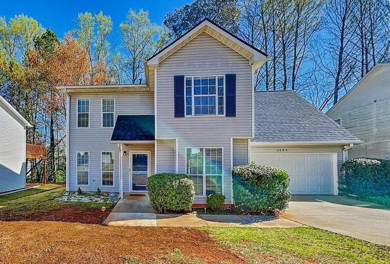 Step inside this beautifully renovated 4-bedroom, 2.5-bath home with a spacious 2-car garage. Modern laminate flooring flows throughout, while the sleek kitchen showcases stainless steel appliances, an island centerpiece, and a convenient breakfast bar. Outdoors, you’ll find a large wooden deck overlooking a tree-filled yard—perfect for gatherings, relaxation, and enjoying the natural surroundings.