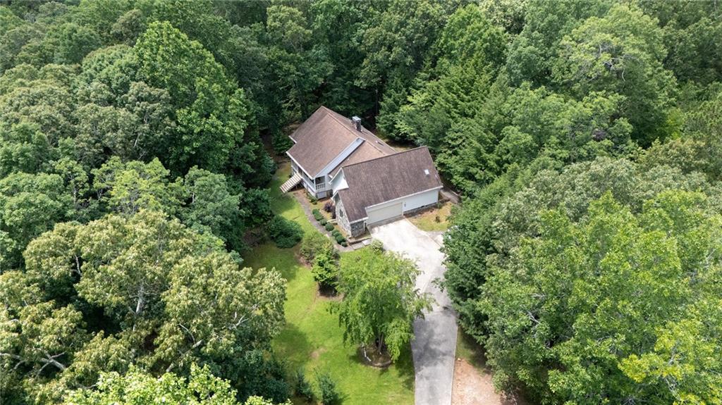 Spacious Retreat on 21.75 Acres in the Heart of Winston Tucked away at the end of a long, winding, tree-lined driveway, this beautiful and expansive home offers exceptional privacy and room to roam on 21.75 acres in the desirable Winston community. Designed with both comfort and entertaining in mind, the home features a partially finished walkout basement with a full bathroom-perfect for hosting gatherings, creating a media room, or accommodating guests. Upstairs, a massive walk-up attic is already stubbed for an additional bathroom and offers endless potential for a flex space, home office, or extra bedrooms. The main level boasts a generously sized master suite with a large en-suite bath and dual closets. On the opposite side of the home, just off the kitchen, are two additional bedrooms and a full bath-ideal for family or guests. Whether you're dreaming of serene country living or need a home with space to grow, this property delivers versatility, charm, and tranquility in equal measure.