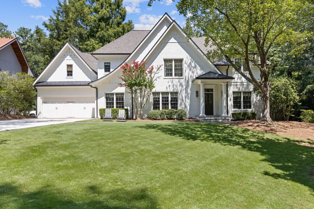 Welcome to a rare gem in the heart of Buckhead! A beautifully renovated Tudor style home set on an exceptionally private, flat 1 acre lot, perfectly positioned across from a serene nature preserve. This elegant 5-bedroom, 4.5-bathroom home offers the best of sophisticated living filled with charm, character, warmth and modern touches. Step inside to discover a magazine worthy home, with an effortless flow that's perfect for both everyday living and entertaining. The main floor offers a dedicated office space, large dining room and a show stopping great room with soaring vaulted, beamed ceilings. The gourmet kitchen has been recently renovated and features beautiful quartz countertops and top-of-the-line appliances. The kitchen opens to a cozy keeping room with a double-sided fireplace shared with the dining room, creating the perfect setting for gathering and conversation. Ideal for guests, the main floor also offers a bedroom and ensuite bathroom. Upstairs, the home's thoughtful layout includes a loft space, spa-inspired, vaulted primary suite with fireplace, three additional bedrooms, two additional bathrooms and a laundry room with sink and incredible storage. The flat backyard offers the ultimate blank canvas, ready for your dream pool or outdoor oasis. This home truly is a can't miss! A rare combination of privacy, location, and timeless design just minutes from the best of Buckhead!