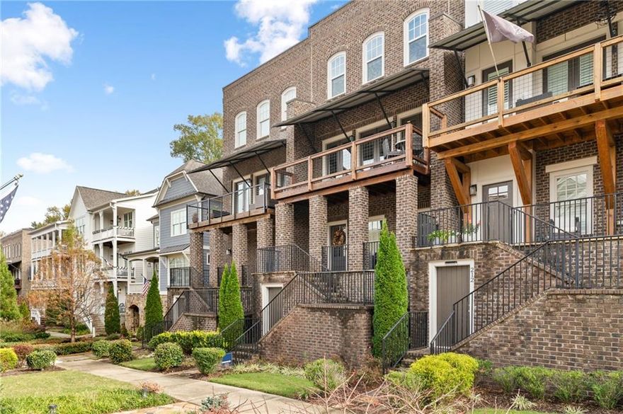Rare find within walking distance of Marietta Square. Enjoy this small community of mixed-style homes with parks, outdoor sitting areas, firepits, and more. This townhome is bright and open, with 8ft interior doors and an abundance of windows flooding the home with daylight. Watch the fireworks from Marietta Square off your private balcony. Enjoy the warmth of the hardwood floors, open and cozy floorplan, and the inviting kitchen with white cabinets, granite countertops, stainless steel appliances, wine fridge, and island with built-in microwave.  The spacious master suite is daylit and features and ensuite bathroom with a beautiful soaking tub, separate shower and large walk in closet. Plenty of storage.  Other features include a private two-car garage, storage closets, two covered porches, and more. Don't miss this one!