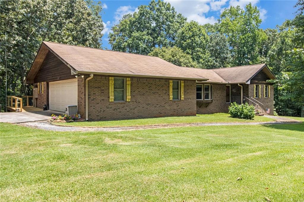Check out this amazing 3-bedroom ranch set on 15 ACRES and just a few minutes from Young Americans Christian School!!! IN-LAW APARTMENT in basement!!! PLUS there is a SECOND three-bedroom house that can be used to generate rental income. No HOA. Don't wait! Call now to schedule a tour. This property won't last long! A full basement with a beautifully designed living space. This is a dream for nature lovers, featuring a barn/workshop, and serenity! The home offers solid raised panel doors, a spacious living room with gorgeous built-ins and a dining area that flows seamlessly into a wonderful sunroom that brings in so much natural light. Kitchen is outfitted with stainless steel appliances and a walk-in pantry that is sure to delight the house chef. The finished basement features a bedroom and full bathroom with kitchenette; ideal for an in-law setup or could be an income-producing space. Right from the basement, step outside onto a covered patio and then continue to the accessory dwelling that has 3 bedrooms and 1 bathroom and a central heat pump, just waiting to be customized with your vision. While outside, check out the barn that has five roll up doors plus an awesome workshop for the DIY enthusiast. Brand new oversized deck is sure to be the hit spot for family time and entertaining. The acreage is ideal for relaxing and taking in the surroundings, picking blueberries from one of many bushes, swinging, or hammocking in an expansive, private setting. Approximately three miles from the sought-after. Fantastic buy for owner-occupant that has a creative concept for developing the property further and living off the land. This is also a great opportunity for an investor/developer. Come with your dreams and tour today!