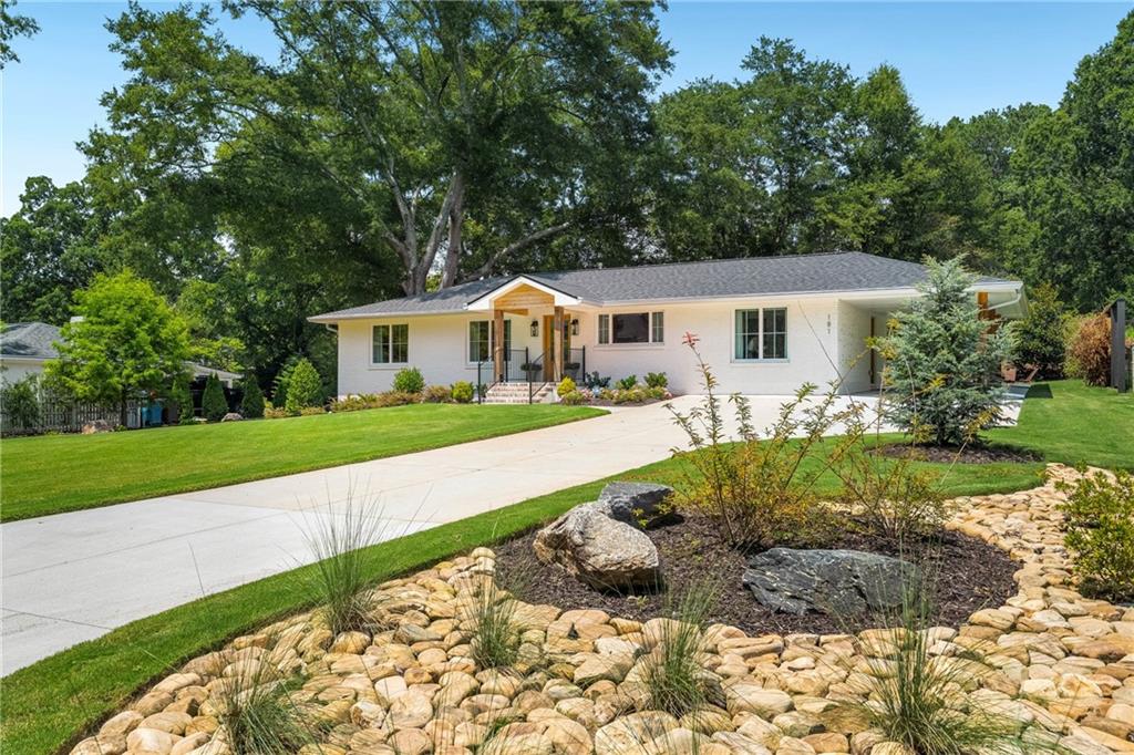 A Rare Garden District Gem – Brand New Build, Timeless Luxury!
Welcome to a masterfully rebuilt and expanded single-level home in Alpharetta’s sought-after Garden District—where timeless craftsmanship meets modern design. Completely reconstructed down to the foundation and issued a Certificate of Occupancy, this home is move-in ready for a quick close.
From the moment you arrive, the attention to detail is undeniable. Casement windows and Mahogany Honduras doors flood the interiors with natural light, while designer lighting and red oak hardwood floors create a warm, elegant atmosphere.
At the heart of the home, the chef’s kitchen impresses with a Thermador 6-burner gas range, Fisher & Paykel refrigerator, and custom-milled 300-year-old white oak cabinetry finished with handmade hardware. A custom FOBEST fabricated vent hood from the Pacific Northwest Corporation and quartz countertops complete this true culinary showcase.
The floor plan offers three bedrooms and three full baths, including a primary suite with a freestanding soaking tub and walk-in shower. The third bedroom is designed for versatility, doubling as a home office with a built-in double Murphy bed for guests.
This home is built for peace of mind, with new plumbing, wiring, buried power lines, commercial-grade copper piping, dual water lines to the meter base, and a brand-new sewer line with a backflow preventer valve. Additional upgrades include a tankless gas water heater, whole-house water filtration, blown-in Celsius insulation, a new architectural shingle roof, and a brand-new, high-efficiency HVAC system.
Step outside to a professionally landscaped, flat backyard, featuring a Sequoia tree sourced from California’s Sequoia National Forest and a full irrigation system - front and backyard. A one-car carport and walkable access to downtown Alpharetta, Avalon, the Alpha Loop, dining, shopping, and GA-400 complete this exceptional property.
This is more than a home—it’s a statement of craftsmanship, design, and location.