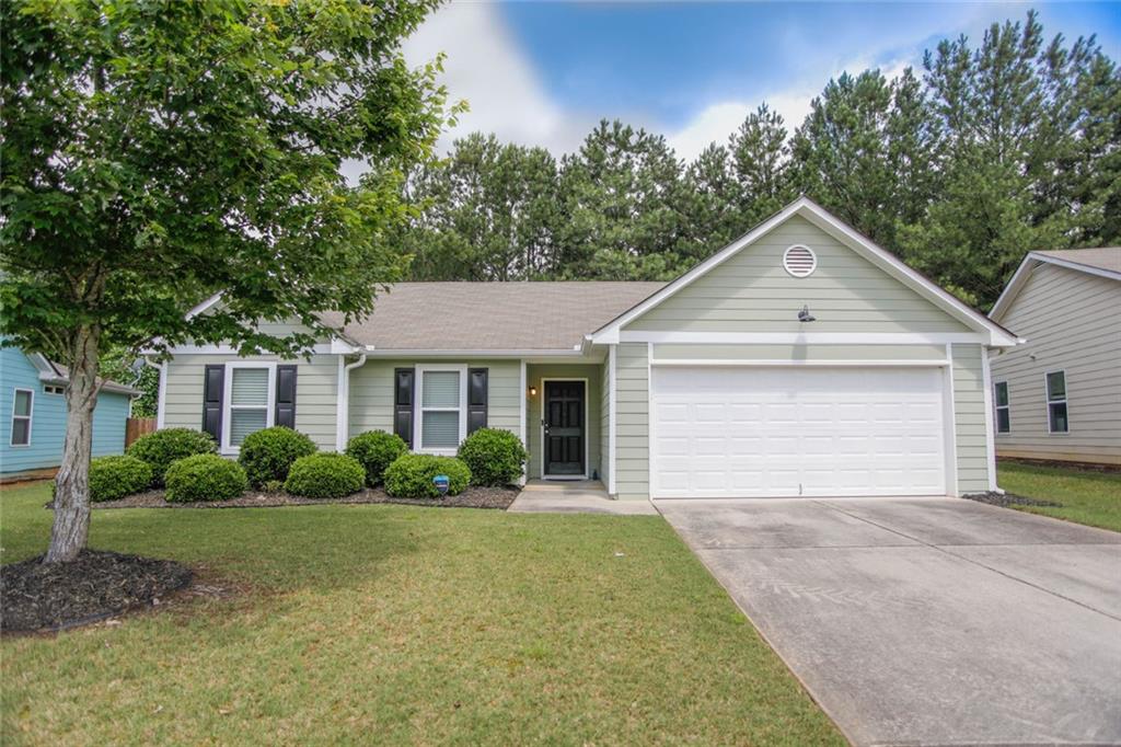 Welcome to Vineyard Gate. Move-in ready ranch home that backs up to wooded private space. This home features a true owner suite with full bath and walk-in closet. Plenty of room for large furniture. Cozy and welcoming. Second full bath is shared by the two secondary bedrooms. Wide hallways throughout, level driveway and easy entry to kitchen from garage. No steps to the front porch, into the home, or from the living area to the back patio. The large living area is open to the kitchen and the breakfast room/dining area. Back patio is a great retreat, with no homes behind. Privacy fence in back yard. Homeowners association with sidewalks and street lights, overflow parking for guests. MUST SEE! HOA covers trash pickup, yard maintenance, street lights and overflow parking. Lock and leave lifestyle with easy access to I-85. Braselton shops and restaurants are only 2 miles away, community gathering areas and a great walk/ride bike neighborhood.