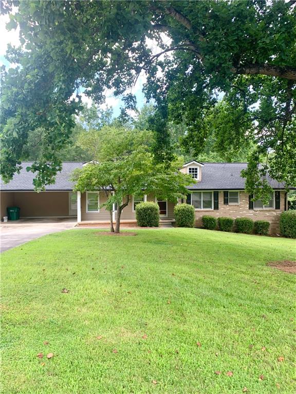 Great Location! Spacious 3-Bedroom, 2-bath ranch on a beautiful level lot. This home features an eat-in kitchen with ample cabinets and counter space, a large laundry room with storage shelves and closet, and new flooring throughout. The family room opens to a generous deck--perfect for entertaining. Conveniently located near I-285 and just minutes from the Peachtree Corners Town Center. Move-in ready and full of potential!