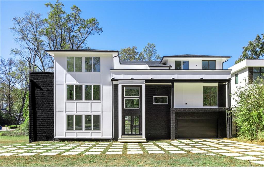 1410 LaVista is an incredible opportunity ready to be customized to suit your lifestyle. Situated in LaVista Park— one of Intown’s most desirable neighborhoods, you'll find large lot sizes and an amazing sense of community and unmatched centrality to Emory, CHOA, the CDC, Midtown, and Buckhead. Step inside to soaring ceilings and open-concept living creating a bright atmosphere perfect for both everyday living and entertaining. The stunning kitchen is flooded with natural light highlighting sleek modern design. Features include custom cabinetry, massive waterfall quartz island and backsplash, dual faucet sink, views to the living room, and walk-in pantry connecting to elegant formal dining. Floor-to-ceiling windows featuring sliding doors lead out to an open deck ideal for sunlit lounging or al fresco dining. Spacious flat yard with tree-lined street providing privacy. Convenient guest bedroom on main with full bath access adjacent to a spacious three car garage and elevator-capable design to all three levels. Upstairs, the expansive primary suite is a true sanctuary with plenty of space for a sitting area. Featuring a spa bath with dual rain shower, freestanding soaking tub and spacious walk-in closet. The primary suite is separated by a spacious open loft leading to two additional bedrooms. Third level features two private rooftop terraces, two additional bedrooms—each with access to a full bath—plus a media room, laundry room, and office space offering flexibility. Don’t miss your opportunity to complete this extraordinary luxury home in one of Atlanta’s premier neighborhoods!