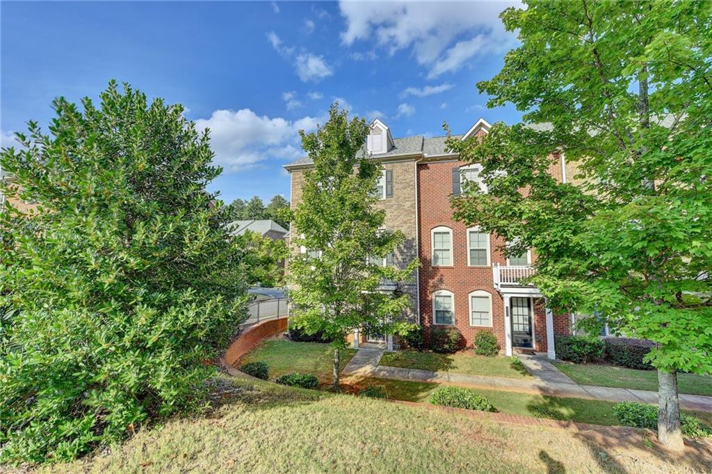 Former model home; Amazing light filled End UNit; Hardwood floors throughout; tiled baths; Open conncept with Chef's kichen featuring stainless steel appliances, granite counter tops, subwy tiled backsplash, island, custom wood cabinets, breakfast area with door to deck and views the dramatic fireside family room and dining area; glamorous owner's retreat is upstairs with a trey ceiling, walk-in closet, garden tub, separate shower, dual vanities and tiled floors; 2 additional bedrooms, tiled guest bath and a laundry room upstairs; Terrace level features a 4th bedroom, 3rd full bathroom; 2 car rear entry garage; minutes to Avalon, downtown Alpharetta, North Point mall, Ameris Amphitheatre, Greenway, Windward business center, medical facilities, dining options.
Only small pets allowed with pet fee determined on breed and weight.