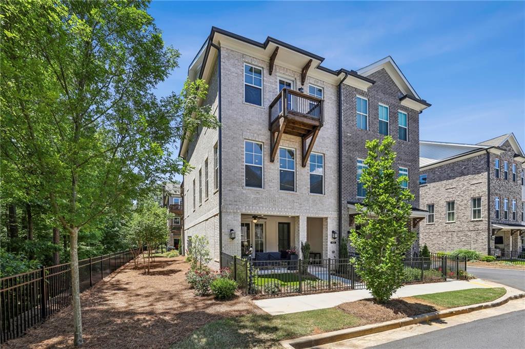 Stunning luxury end-unit Townhome with professional interior design selections and upgrades throughout! Enter this amazing brownstone inspired townhome through its lush turf courtyard, landscaped and lined with a wrought iron privacy fence. You will be greeted by its charming private bricked patio, complete with an outdoor fireplace and plenty of sitting area. Once inside, the Terrace Level showcases a comfortable Media Room with many options for use. On this level also is the easy access Garage with space for two cars.
The Main Level boasts an open floorplan layout of the Kitchen, Dining Area and Living Room. The striking Kitchen showcases a large island, white quartz countertops, painted cabinets to the ceiling, stainless appliances, a gas cooktop, range hood, and a walk-in Pantry. Modern hardware and lighting choices all made alongside designers at time of build. The Kitchen is open to the Dining Area with space for a large dining table for easy entertaining. Across the room is the generous sized Living Room with two walls of natural light filled windows, and plenty of space for sectional seating. The Living Room is also anchored by a curated hearth and trimmed-out fireplace with modern hanging bookshelves that remain. The fireplace is vented with a gas log insert for easy use. The 65" TV hung above the fireplace also remains with the townhome! On the rear-side of the main level is light-filled Office, gorgeous wall-papered Powder Room and easy-access Laundry Room. The upgraded GE smart washer and dryer both will stay with the home also (wifi-enabled). A covered Deck is also off of the Main Level, perfect for morning coffee or lunch outside.
The Upstairs Level is home to the Master Bedroom, and two secondary Bedrooms. The Master Bedroom is generous in size, and has a trey-ceiling with fan. A Juliet-balcony can be found off of the Master Bedroom for fresh air or cool nights. The Master Bedroom's walk-in Closet has been well-upgraded with a California Closet system including many useful storage features and a stack of drawers. The Master Bathroom offers his and hers vanities, dark hardware, painted cabinetry and modern fixtures. A separate soaking tub, oversized spa shower (traditional, rain shower and hand shower faucets), and designer tile selections make this Bathroom a modern luxury. Across the landing are two stunning secondary bedrooms adorned in designer paint selections and both with their own access out to an open air deck overlooking the trees. This home has hardwood style floors throughout the entire home for a modern and clean lifestyle. All custom window treatments and hardware will remain for a seamless move-in. A tankless water heater, insulated windows and smart utility features make comfortable living also efficient.
Throughout the Atley community you will find unbeatable amenities and lifestyle luxuries. With direct access to the incredible Alpha Loop walking trail, a short walk leads to both the Avalon and downtown Alpharetta's shopping districts. Restaurants, boutiques and nightlife are just steps from home with winding sidewalks and well lit streets! Atley has a gorgeous swimming pool with resort style cabanas, perfect for relaxing with a book. The dog park is a popular spot to meet up with friends, and the community garden is a unique hobby area for those who like to grow their own flowers or herbs. Atley is a lushly landscaped community but also a secure and safe with its gated entrance. All yard care, exterior home maintenance, and trash service is included in the HOA membership. For those commuting to Atlanta or the airport, highway 400 is just one mile close! Top school district: Manning Oaks ES, Northwestern MS, Milton HS.