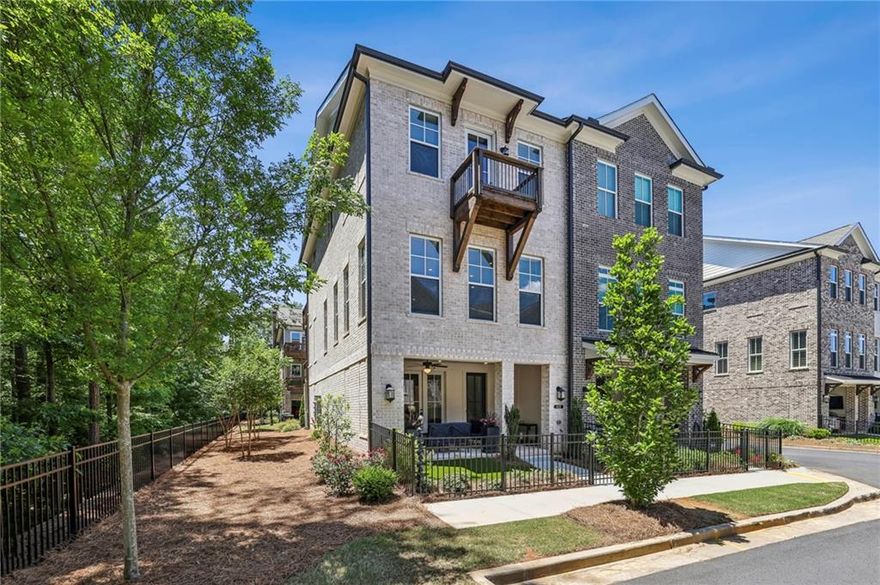 Stunning luxury end-unit Townhome with professional interior design selections and upgrades throughout!  Enter this amazing brownstone inspired townhome through its lush turf courtyard, landscaped and lined with a wrought iron privacy fence.  You will be greeted by its charming private bricked patio, complete with an outdoor fireplace and plenty of sitting area.  Once inside, the Terrace Level showcases a comfortable Media Room with many options for use.  On this level also is the easy access Garage with space for two cars.  

The Main Level boasts an open floorplan layout of the Kitchen, Dining Area and Living Room.  The striking Kitchen showcases a large island, white quartz countertops, painted cabinets to the ceiling, stainless appliances, a gas cooktop, range hood, and a walk-in Pantry.  Modern hardware and lighting choices all made alongside designers at time of build.  The Kitchen is open to the Dining Area with space for a large dining table for easy entertaining.  Across the room is the generous sized Living Room with two walls of natural light filled windows, and plenty of space for sectional seating.  The Living Room is also anchored by a curated hearth and trimmed-out fireplace with modern hanging bookshelves that remain.  The fireplace is vented with a gas log insert for easy use.  The 65" TV hung above the fireplace also remains with the townhome!  On the rear-side of the main level is light-filled Office, gorgeous wall-papered Powder Room and easy-access Laundry Room.  The upgraded GE smart washer and dryer both will stay with the home also (wifi-enabled).  A covered Deck is also off of the Main Level, perfect for morning coffee or lunch outside.  

The Upstairs Level is home to the Master Bedroom, and two secondary Bedrooms.  The Master Bedroom is generous in size, and has a trey-ceiling with fan.  A Juliet-balcony can be found off of the Master Bedroom for fresh air or cool nights.  The Master Bedroom's walk-in Closet has been well-upgraded with a California Closet system including many useful storage features and a stack of drawers.  The Master Bathroom offers his and hers vanities, dark hardware, painted cabinetry and modern fixtures.  A separate soaking tub, oversized spa shower (traditional, rain shower and hand shower faucets), and designer tile selections make this Bathroom a modern luxury.  Across the landing are two stunning secondary bedrooms adorned in designer paint selections and both with their own access out to an open air deck overlooking the trees.  This home has hardwood style floors throughout the entire home for a modern and clean lifestyle.  All custom window treatments and hardware will remain for a seamless move-in.  A tankless water heater, insulated windows and smart utility features make comfortable living also efficient.

Throughout the Atley community you will find unbeatable amenities and lifestyle luxuries.  With direct access to the incredible Alpha Loop walking trail, a short walk leads to both the Avalon and downtown Alpharetta's shopping districts.  Restaurants, boutiques and nightlife are just steps from home with winding sidewalks and well lit streets!  Atley has a gorgeous swimming pool with resort style cabanas, perfect for relaxing with a book.  The dog park is a popular spot to meet up with friends, and the community garden is a unique hobby area for those who like to grow their own flowers or herbs.  Atley is a lushly landscaped community but also a secure and safe with its gated entrance.  All yard care, exterior home maintenance, and trash service is included in the HOA membership.  For those commuting to Atlanta or the airport, highway 400 is just one mile close!  Top school district:  Manning Oaks ES, Northwestern MS, Milton HS.