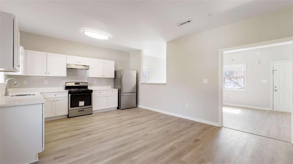 Welcome to 848 Ridge Avenue NW, Unit A-an updated, townhome-style duplex unit located in Atlanta's dynamic and fast-growing Westside. This spacious 3-bedroom, 2.5-bath residence offers the perfect blend of modern comfort and urban convenience, with 1,410 square feet of thoughtfully designed living space across two levels. Set in the quiet Maple Ridge community, this home provides privacy, flexibility, and proximity to the city's best amenities. Step inside to an open-concept main level featuring luxury vinyl plank flooring, recessed lighting, and a neutral palette ready for your personal touch. The kitchen is both stylish and functional, offering crisp white cabinetry, stone countertops, a full pantry, and a clear view to the family room-making entertaining easy and everyday living seamless. A main-level laundry area and convenient half bath round out the first floor. Upstairs, you'll find three generously sized bedrooms, including a well-appointed primary suite complete with a walk-in closet and a private bath featuring a double vanity and tub/shower combo. Two additional bedrooms share a second full bath, making the home ideal for roommates, families, or anyone needing extra space for a home office or guests. Enjoy peaceful mornings and evenings from your private front porch or rear patio. This unit includes private entry, off-street parking for two vehicles, and no HOA. Located minutes from the BeltLine Westside Trail, Westside Park, Mercedes-Benz Stadium, Georgia Tech, and the bustling shops and restaurants of West Midtown and Atlantic Station. With easy access to MARTA, major highways, and public schools like Woodson Park Academy, John Lewis Invictus Academy, and Frederick Douglass High School, this location offers unbeatable convenience. Additional features include central heating and air, double-pane windows, and carbon monoxide/smoke detectors. The home is pet-friendly (deposit may apply). Tenant is responsible for all utilities. Available for immediate move-in. Don't miss the opportunity to lease this spacious, move-in-ready home in one of Atlanta's most promising neighborhoods. Schedule your showing today and experience life at 848 Ridge Ave NW, Unit A.