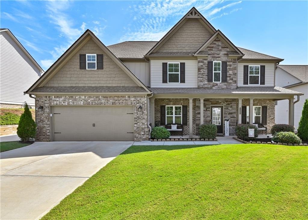 DON'T MISS OUT ON THIS STUNNING LIKE NEW HOME IN PRISTINE CONDITION!!! This 5 bedroom, 4 bathroom home in a quiet family friendly community in the top-rated Mill Creek school district! The home is a beautiful open concept floor plan with a gourmet kitchen with TONS of cabinet space and an oversized island with granite counters and stainless steel appliances that over looks the family room! There is a separate dining room that has access to the kitchen for those big family Sunday or Holiday dinners. On the main level there is also a formal living room that can be used as an office or flex space along with the guest bedroom and full bathroom. Upstairs is the oversized master suite with a huge walk-in closet and the other secondary bedrooms, one with its own ensuite bath. There is also an oversized loft area or media room that is perfect for movie or game nights. To top off this beautiful home is the nice sized oasis backyard with a screened in porch perfect to watch your favorite sports and grill and chill along with a hot tub and fire pit! Perfect to enjoy all year long no matter what season it is! This home also has the perfect curb appeal with the well maintained front and backyard lawn with beautiful landscape! All of this in a fantastic location near the Mall of GA area with dining, shopping, entertainment and close to highway 85. Please, come and see for yourself of what your dream home can look like!!
