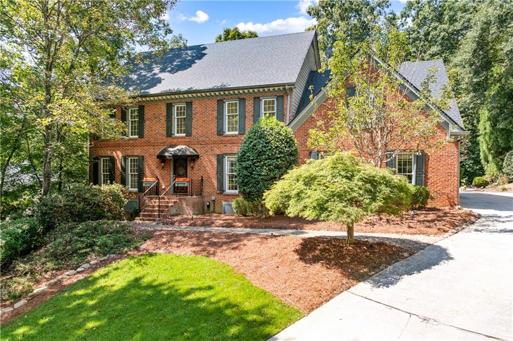 Nestled in the prestigious River Bluff community, do not miss this stately 4 sided brick beauty. S lovely leaded glass door welcomes you into the elegant entry foyer. On one side is the oversized dining room that seats 12+. A gorgeous chandelier and beautiful wall sconces make this room so elegant and appealing. The hardwood floors are warm and welcoming. Floor to ceiling windows let in so much natural light. An oversized living room/drawing room on the other side of the foyers features 10 ft smooth ceilings and so much room for entertaining and socializing. This room leads to the beautifully appointed Great Room with custom shelving, a wood burning fireplace with gas starter, and a wet bar, hidden behind beautiful oak doors. Off of this room is a charming room which overlooks the huge deck and lush verdant back yard with two spectacular water features. Floor to ceiling windows gives you a panoramic view of the entire deck and back yard. backyard. The gourmet kitchen is a chef’s dream, with top of the line stainless appliances, beautiful custom cabinetry with leaded glass inserts, and so much storage. Countertops are a beautiful granite with a huge island, making cooking and entertaining a joy! The breakfast room also features beautiful shelving and cabinetry and overlooks the back deck and back yard. The laundry room features a sink, washer and dryer, and a convenient powder room. So much storage in this area! Upstairs, the are 4 oversized spacious bedrooms, all light and bright, with custom closets. All secondary bedrooms feature Jack and Jill baths. The spa like primary bedroom features a sitting area with architectural details. The primary bath features a jetted tub and separate shower. There are double vanities and a separate cabinet, perfect for a make-up station or a coffee bar!! Bedroom features a custom California closet. The terrace level features a bedroom, full bath, and a Great room with wood burning fireplace, and exterior entry. It also hosts a custom designed WINE CELLAR, with a beautiful mural, tasting area, and lot of storage. The roof is TWO WEEKS OLD, heating unit is newish, and terrace level has only recently been finished.
