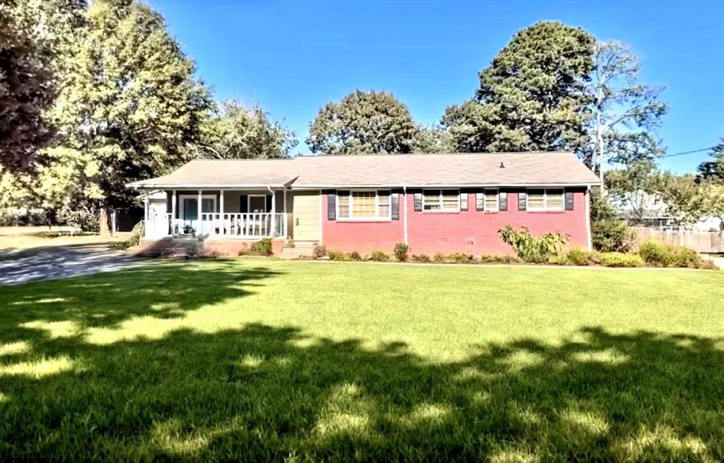Charming 3BR/2BA Ranch with Detached Garage & Workshop! Welcome to this cozy ranch home ideally located on a quiet street just minutes from Hwy 78, Hwy 124, I-285, shopping, dining, and the scenic Stone Mountain Park. This well-maintained 3-bedroom, 2-bathroom home offers a bright and airy family room with laminate flooring and a cozy fireplace. A separate formal living room provides the perfect setting for gatherings or quiet evenings. Sitting on a beautifully landscaped 0.41-acre lot, the property features fruit trees, a fully fenced backyard, and a spacious deck perfect for outdoor entertaining or relaxing. You'll also appreciate the detached 2-car garage with an attached workshop, ideal for storage, hobbies, or weekend projects.