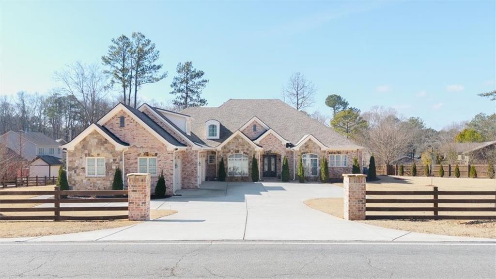 Exquisite Custom-Built 4-Sided Brick Home in East Cobb’s Top School District!
Discover unparalleled craftsmanship and luxurious living in this stunning custom-built, four-sided brick home, situated on nearly an acre in the highly sought-after East Cobb school district with the benefit of low Cobb County taxes. Showcasing the finest finishes and superior construction, this home is a true masterpiece!
From the moment you arrive, the impressive curb appeal sets the tone. A gated entrance leads to a wide driveway, offering ample parking for multiple vehicles. Built just five years ago, this residence boasts impeccable design and high-end features throughout, promising a lifestyle of elegance and comfort.
Step inside to an inviting open floor plan that seamlessly blends the living room, dining area, and kitchen—creating the perfect space for both entertaining and everyday living. Large windows flood the home with natural light throughout the day, while soaring ceilings enhance the sense of space and openness.
The heart of the home is the fully equipped chef’s kitchen, complete with an oversized center island ideal for hosting or casual dining. Gleaming quartz countertops, abundant cabinetry, top-of-the-line stainless steel appliances, and a spacious walk-in pantry provide both beauty and functionality.
The expansive living room features a stunning fireplace as its focal point, adding warmth and elegance to the space. The oversized owner’s suite is a private retreat, boasting gorgeous tray ceilings, bay windows, and a spa-like en-suite bathroom with a jetted soaking tub and a large, frameless glass shower.
Three additional generously sized bedrooms on the main level each come with their own en-suite bathrooms, ensuring ultimate comfort and privacy for family and guests.
Upstairs, you’ll find a full apartment-like suite, complete with its own living room, entertainment area/home theater, an additional bedroom, and a full bathroom—perfect for extended family or guests.
Step outside to the gorgeous covered back patio, an outdoor oasis where you can enjoy your morning coffee in peace or unwind with a glass of wine at the end of the day.
Practicality meets luxury with a spacious three-car garage, designed to accommodate vehicles of all sizes while still providing plenty of storage. Additionally, the detached covered parking area offers the perfect space for your RV or boat.
And let’s not forget—location is everything! Situated right off Sandy Plains Road and Piedmont Road, this home is just minutes from I-75 and I-575, within walking distance to top-rated schools, shopping, dining, and entertainment.
Don’t miss your chance to own this exceptional retreat—schedule your private tour today!