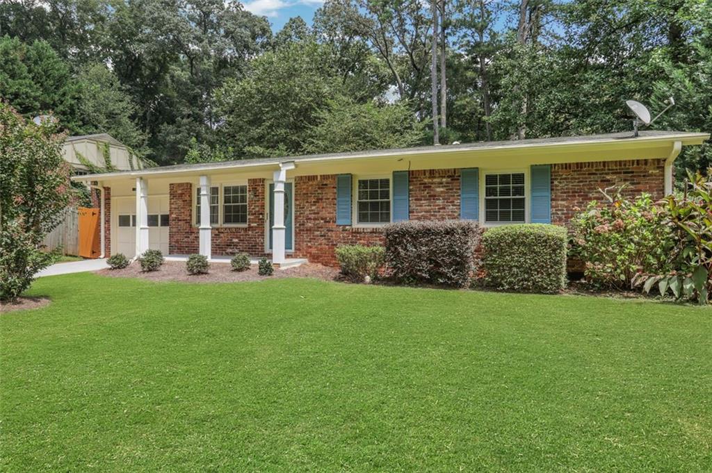 Beautifully maintained four-sided brick ranch with 3 bedrooms and 2 baths situated on a large, landscaped lot in a prime location. This home features a sound system for the living room and back deck, a true walk in laundry room, solid hardwood floors, a modern kitchen with granite countertops, tiled backsplash, and stainless steel appliances. The primary suite offers an updated bath with a tiled shower and floors. Additional highlights include a professionally landscaped fenced backyard with a fire pit, a tankless water heater, a Trane HVAC system for comfort and efficiency, and an encapsulated crawlspace. Located just minutes from I-285 and Highway 20. Enjoy unbeatable convenience with close proximity to restaurants, shops, and businesses in downtown Decatur, plus just minutes from the renowned Dekalb Farmers Market. The home also offers an easy commute to major employment centers including Emory University, the CDC, and Children’s Healthcare of Atlanta. Outdoor enthusiasts will love the direct access to the Stone Mountain PATH Trail—just a short walk from the front door.