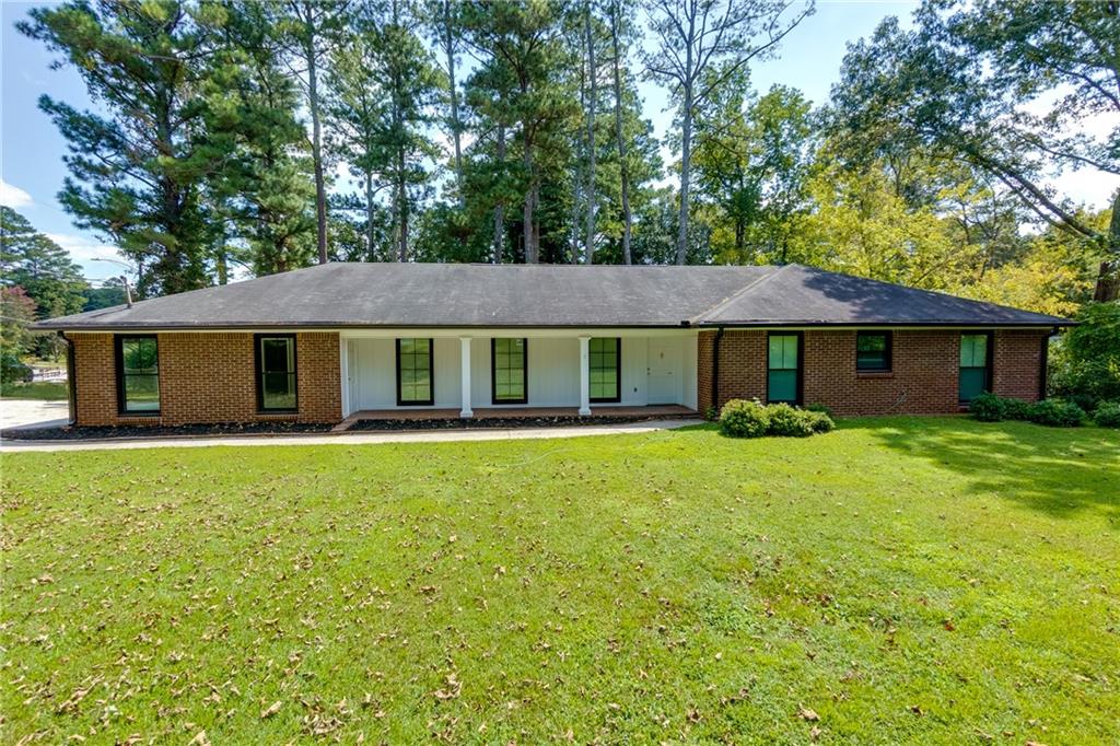 Looking for a charming ranch in the heart of Marietta with NO HOA and completely updated? Look no more! This classic one level home features 4 bedrooms and 2 full bathrooms. Enter the home into a foyer to be greeted with loads of natural light, updated flooring, and neutral paint throughout with a spacious floor plan. Just off the foyer you will enjoy a large den perfect for entertaining or unwinding, as it it attached to the formal dining room. This den space could easily be converted into a flex space for a home office, playroom, or study. The dining room is spacious, has updated lighting, and joins the kitchen for your convenience. The kitchen offers wood cabinets, granite countertops, white tile backsplash, and updated stainless steel appliances. There is also a casual dining space in the kitchen with a great view into the backyard. Continue on to the primary suite where you will enjoy a generous sized bedroom complete with closet and en suite bath. The master bath offers a beautiful walk in tile shower, updated vanity & mirror, and new fixtures. The additional 3 bedrooms are also spacious and share the second full bath with shower-tub combo, updated fixtures, and vanity. This home also offers a laundry room just off the kitchen with additional storage cabinets, counter space, and a brand new washer & dryer that are included with the home! Take in the outdoors with a sprawling lot featuring a back patio, fenced yard, and established shrubbery and trees. This home offers loads of curb appeal with a classic brick front, covered front porch, a large front yard, and easy to maintain landscaping. A brand new driveway leads to the side entry, two car garage where you will find additional storage space within. There is also a shed in the backyard for additional outdoor storage. Updates Include: New HVAC, new washer & dryer, updated appliances, new outlets, new fixtures, new driveway, and a complete renovation that includes new flooring and paint, professionally installed new insulation throughout, and brand new windows throughout making this property highly energy efficient and helping to reduce those utility bills in both Summer and Winter. This home truly offers it all in a highly sought after area of East Cobb with easy access to local shops, restaurants, top rated schools including Pope High School (rated 9/10), and easy commutes! Area highlights include fantastic local parks and community areas such as Marietta Square, The Atlanta Braves Battery, and more.