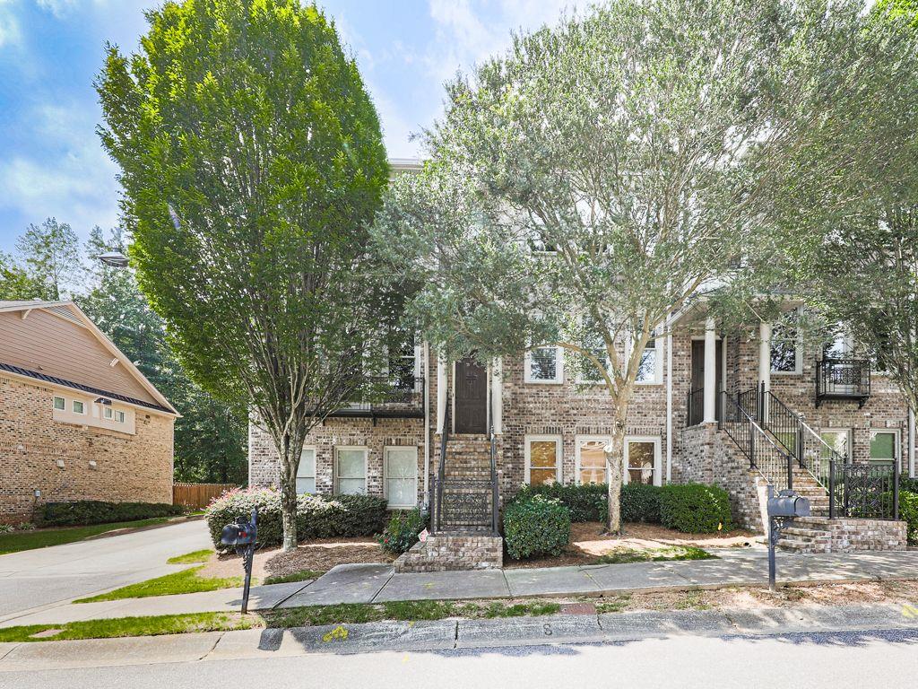 Quietly nestled in the convenience of Alpharetta, this custom end-unit townhome exudes luxury with it's high-end finishes and generous floor plan. Complete with hardwoods throughout, upgraded trim package, granite countertops, stained cabinets and more. The private dining room, gourmet kitchen, half bath and large family room are on the main floor with access to your private balcony overlooking a wooded area. Relax in the oversize owners' suite with a private sitting area, his and her walk in closets,fireplace and luxurious ensuite. Upstairs has 2 additional bedrooms, full bath and laundry. The lower floor is perfect for a home office, gym, or flex room with full bath. Close to local shops and restaurants, Avalon, Halycon and easy asses to GA-400 yet private enough to retreat from life's stresses. Hidden Forest is a gated community with swimming pool and dog park. If you are looking for a place to call home while still feeling connected, this is your new home!