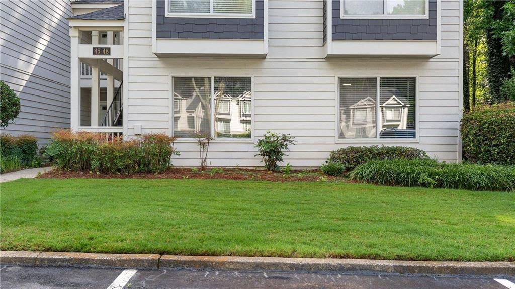 Welcome to this beautifully updated 2-bedroom, 2-bathroom condominium offering style, comfort, and convenience just minutes from Truist Park and The Battery! Step inside to discover a bright, open living space featuring accent walls, recessed lighting, and a cozy fireplace—perfect for entertaining or unwinding after a long day. The kitchen is a true standout with granite countertops, stainless steel appliances, a farmhouse double-bowl sink, and a dedicated coffee bar and pantry area. Enjoy morning coffee or evening cocktails on your private covered patio—complete with extra storage space. Retreat to the spacious primary suite featuring an updated bathroom with a stepless shower for added comfort and accessibility. Both bathrooms have been tastefully renovated to reflect modern design trends. Located just moments from top-tier shopping, dining, and easy interstate access, this home is ideal for those who want the best of city living with a quiet, stylish retreat to come home to. Don’t miss this move-in-ready gem in one of the most sought-after areas near Atlanta!