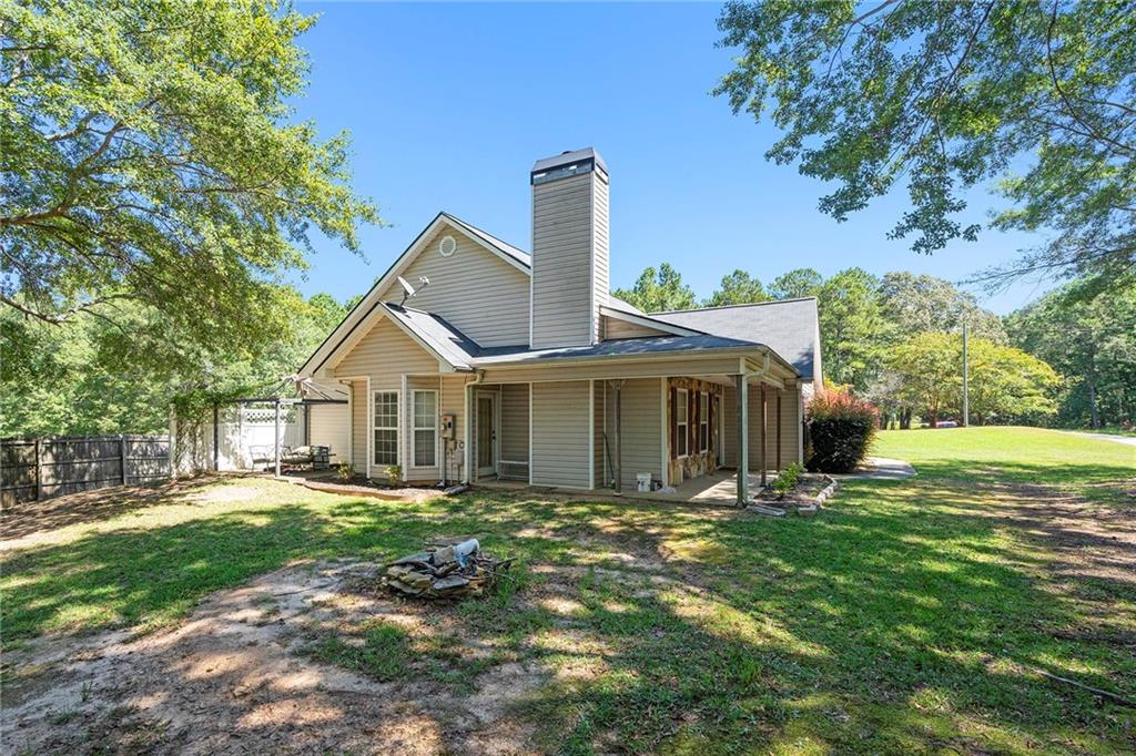 Charming 3 Bedroom, 2 Bath Ranch on 4.78 Acres - Country Living at Its Finest! Welcome to your dream home nestled in the desirable Walnut Grove High School District! Enjoy 3 generous bedrooms and 2 beautifully appointed bathrooms. The master bath boasts an updated tile shower, double vanities, and a large walk-in closet for all your storage needs. The heart of the home is a large kitchen equipped with painted cabinets, a stylish tiled backsplash, and a butcher block island/breakfast bar, perfect for family gatherings and entertaining. Step outside to your expansive 4.78 acres, with over 3 acres cleared and grassed. The backyard and side yard are fully fenced, providing a safe haven for children and pets. Dive into the above-ground pool on hot summer days or enjoy the bounty of your own fruit garden, featuring raspberry, blueberry, elderberry bushes, and a variety of fruit trees including fig, peach, plum, pear, and apple. The property includes a chicken coop for fresh eggs, two outbuildings for extra storage, and an enclosed garage that has been converted into an office space and separate storage area. The home features LVP flooring throughout, with tiled bathrooms for a modern touch. A separate dining room with a cozy sitting area adds to the charm and functionality of this lovely home. This property is perfect for those seeking a peaceful retreat with plenty of space for outdoor activities and gardening. Don't miss the opportunity to own this slice of paradise! Schedule your showing today!