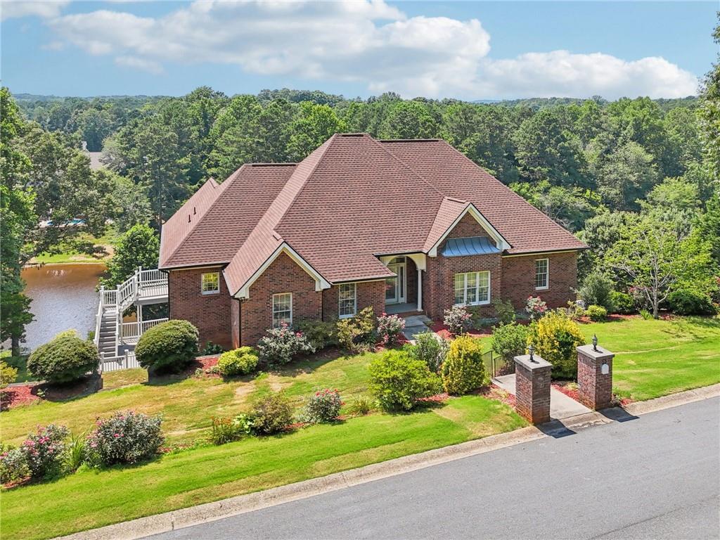 Listed Well Below Appraised Value! Stunning multi-level lakefront home on Spring Lake with breathtaking views and upgrades throughout. Hardwood floors on both levels, no carpet! Main living area features crown molding, fireplace, built-ins, formal dining, and multiple access points to the expansive lakefront deck.
The chef’s kitchen includes a large island with seating, gas cooktop, double ovens, stainless steel appliances, stone countertops, and a walk-through pantry to the oversized laundry/mudroom. Luxurious primary suite offers a see-through fireplace, tray ceiling, private deck, dual walk-in closets, and spa-like bath with double vanities, garden tub, and custom tiled shower. Two secondary bedrooms share an updated double-vanity bath. Lower level features a huge family room with lake views and deck access, plus three bedrooms (including a Jack-and-Jill bath). Massive 3-car garage, abundant storage, and unfinished spaces with a nearby full bath provide endless possibilities. Outside: multi-tiered backyard, private dock, mature trees, and direct lake access for fishing, boating, or relaxing. Don’t miss this rare opportunity—schedule your showing today!