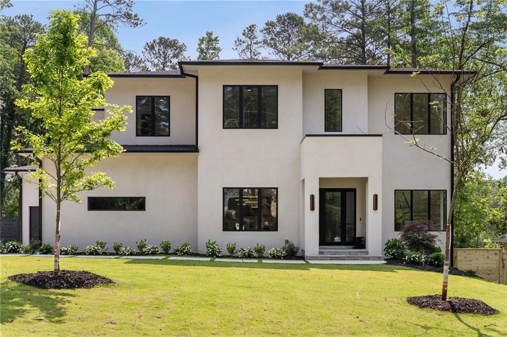 A showcase of refined luxury and modern comfort, this newly constructed estate stands out with a resort-style pool and a FINISHED basement, offering an unparalleled lifestyle in one of Atlanta’s most coveted areas near Lenox. With 6 bedrooms, 7.5 baths, a three-car garage, and elevated design throughout, this exceptional residence is the ultimate private retreat—perfect for both grand entertaining and everyday living. Enter through a stately portico into a dramatic foyer with soaring 12-foot ceilings and striking sightlines. The formal dining room sets the tone for elegant gatherings, while a spacious family room with fireplace, custom mudroom, and main-level guest suite with walk-in closet and private bath ensure both comfort and functionality. A designer powder room adds convenience for guests. The heart of the home is the chef’s kitchen—an entertainer’s dream—featuring a large center island with gas cooktop, walk-in pantry, and a butler’s pantry complete with wine refrigerator and ice maker. The adjoining breakfast room flows seamlessly into the family room, creating an open and airy atmosphere. Upstairs, the expansive primary suite offers a peaceful escape with dual walk-in closets and a spa-inspired bath including a soaking tub, frameless glass shower, and double vanity. Three additional bedrooms—each with their own en-suite bath and walk-in closet—provide ample space for family or guests, while a centrally located laundry room adds ease to daily routines. The finished basement is designed for versatility, boasting a spacious flex area with fireplace, an additional bedroom with full bath and walk-in closet, a second full bath, and generous storage space—perfect for entertaining, relaxing, or future customization. With room for an elevator, meticulous attention to detail, and a location close to premier shopping, dining, and entertainment, this home offers a lifestyle of sophistication and convenience.