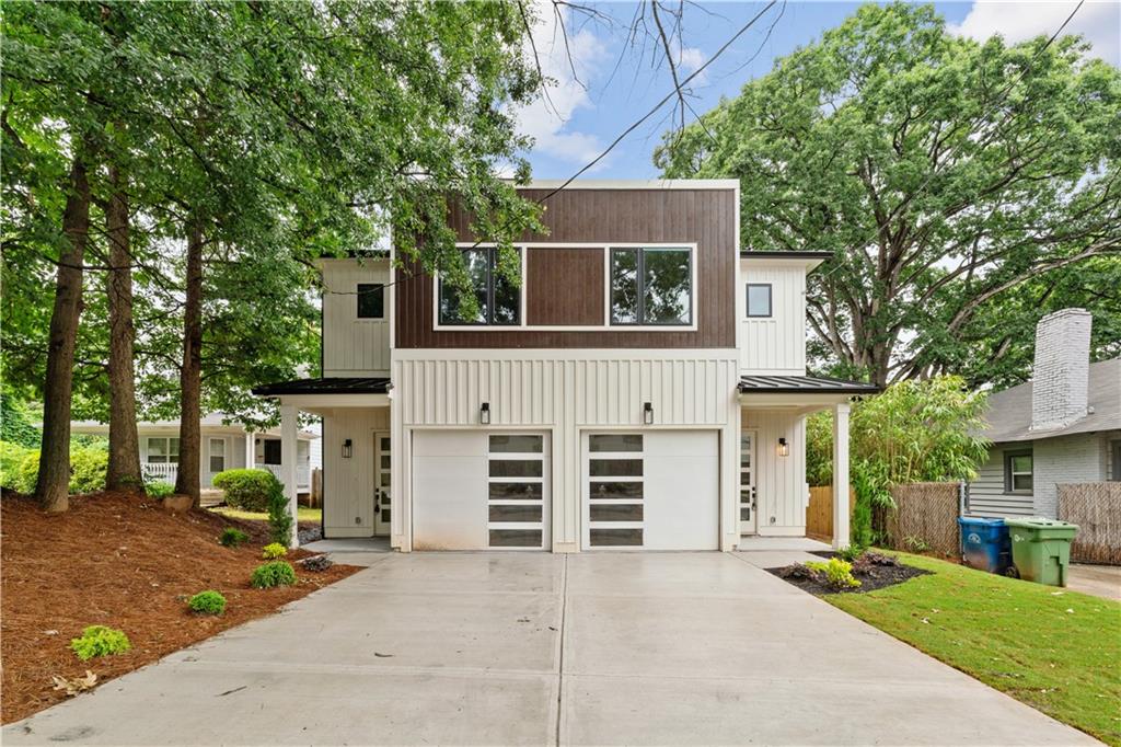Elegant new construction with a private fenced yard, at a hard-to-find price point. Enter the wide front foyer to soaring 10-foot ceilings and stunning finishes in this well-designed townhouse. The open floorplan boasts accent walls, custom lighting and plumbing fixtures, and natural hardwood floors. Don't miss the upgraded "thin" shaker cabinets and oversized quartz island in this impressive kitchen. Separate, but open, dining area flows seamlessly to the back patio and the ample backyard! The open living room is anchored by a cozy fireplace with quartz surround. Main level also features a stylish half bath, mudroom with built-ins, and attached garage, with 240-volt plug-in for electric vehicles. Upstairs you will be wowed by the bonus loft living area, three bedrooms and two more bathrooms. The primary suite will not disappoint - accent walls, sunny bath with dual vanity, dual shower heads and upgraded finishes, and a large private porch with treetop views so peaceful you might forget you're minutes from the Beltline, Madison Yards, Edgewood Retail District, Ponce City Market, and much more. Intown living at its finest!