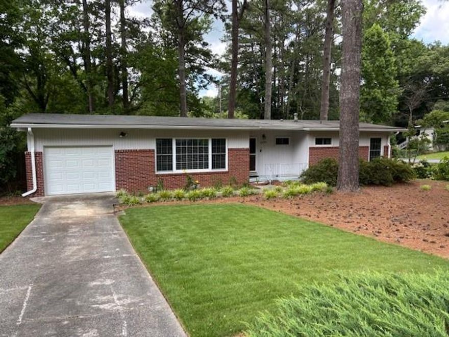 Purchased by the current owners in 1999, this home has been well taken care of and now move-in ready with new recent gutters, new garage door with remote, and fresh neutral paint both inside and out.  Excellent location just minutes from the 120 Loop and I-75, White Water Park, and the Braves Stadium and the Battery.  This home features a corner lot with a small fenced in back yard and a new custom deck which was completed in December 2024.  Seller's offering a one year transferable termite bond at closing.