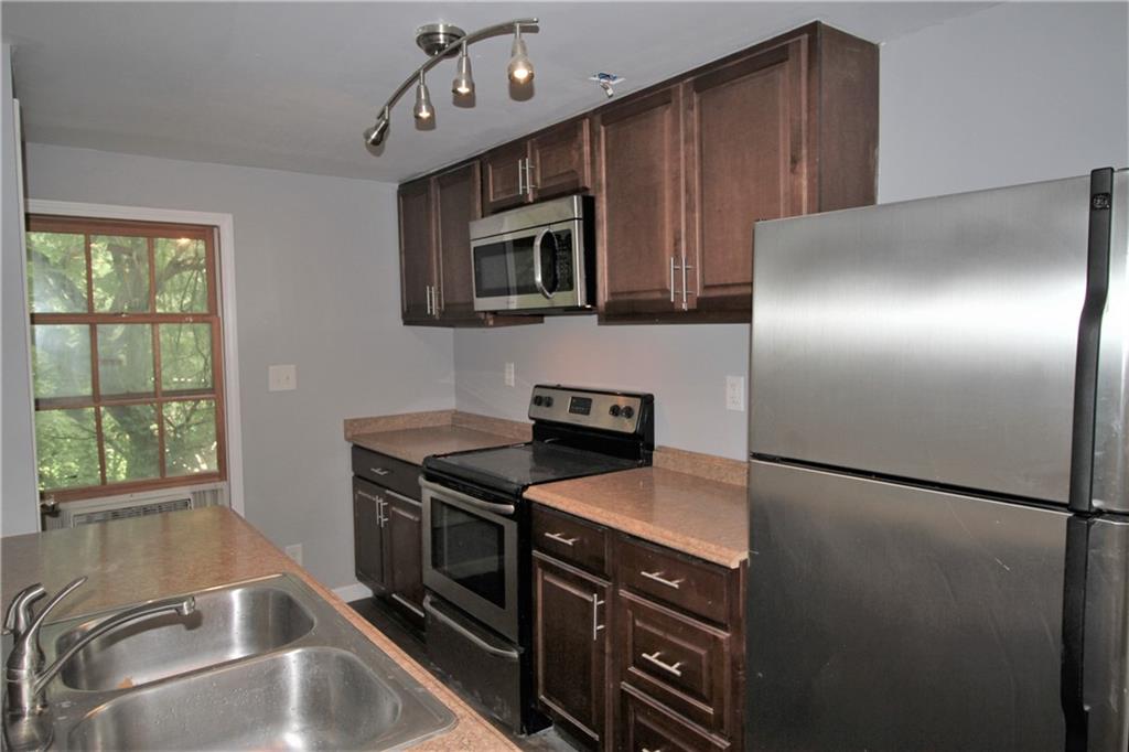 Where else can one live this close to Buckhead, in Brookhaven with access to highways, shopping, restaurants, grocery stores, parks and the P'teee Creek Greenway AND have a private garage for the car, plus private entrance to your secluded "loft" style garage apartment? Here! Only here! One large room encompasses the living/bedroom area. Kitchen is a galley style located right at the entry. There is a stainless steel range, microwave/vent hood and refrigerator. The compact bathroom has all the essentials. This is a ONE ROOM apartment This space is like being in the country surrounded by trees but in the heart of the city. Million dollar homes are all around it. The building is located behind the Triplex, way off the street. Ideal for someone who travels for work.