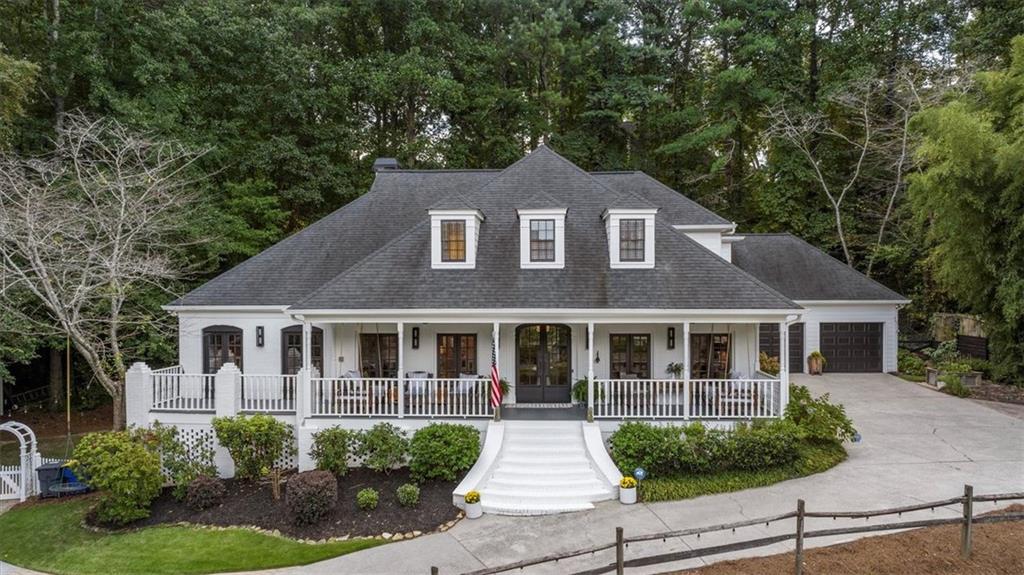 Escape the everyday and arrive at your own private sanctuary in the coveted Fields Pond community. A winding drive past a serene neighborhood pond leads you to a home completely hidden from the road, offering unparalleled seclusion on a wooded cul-de-sac lot. This charming Cape Cod welcomes you with an expansive front porch perfect for enjoying tranquil water views with your morning coffee.
Step inside to discover a thoughtfully designed floor plan with refinished hardwood floors throughout the main level. The heart of the home is the beautifully updated kitchen which has been opened to the family room, creating an ideal space for entertaining. A true cook’s delight, it features granite counters and stainless appliances. Host elegant dinners in the formal dining room with French doors that open to the porch breeze, or retreat to the convenient main-level primary suite offering private deck access.
Upstairs, four additional bedrooms provide ample space for family and guests. The basement can be a perfect independent living or multigenerational space with minor modifications. The basement also has a workshop and a large storage area. Host gatherings on the flagstone patio or find a quiet moment in the garden. Fully fenced backyard! With recent updates including the roof, exterior paint, and HVAC, plus community pool and tennis, this home combines ultimate privacy with modern comfort.