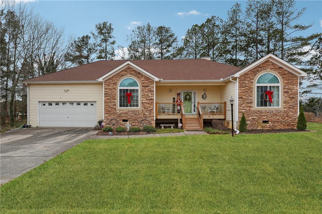 Welcome to 141 Hunters Way, a charming 3-bedroom, 2-bathroom home nestled on a spacious 0.48-acre lot in Villa Rica, GA. This well-maintained property features a desirable split-bedroom floor plan for added privacy. The master suite offers double vanities, a walk-in closet, a relaxing tub, and a separate shower. The inviting living space includes a bright kitchen with a breakfast area, a separate dining room, and a cozy family room. Double doors lead to a large covered back deck, perfect for entertaining or enjoying the serene backyard. The property also includes a 12x24 storage building/workshop, ideal for hobbies or additional storage. With a two-car garage and kitchen-level entry, this home combines convenience with charm. Located in a quiet, established neighborhood with a swimming pool and close to schools, shopping, and dining, this home is move-in ready! Schedule your showing today to see everything this home has to offer!
