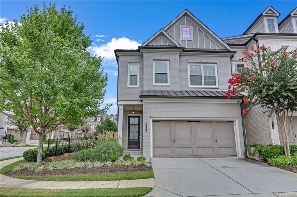 This beautiful luxury townhome is in excellent condition, immaculately clean, and move-in ready. Located in a private gated community, it offers a wonderful lifestyle and is convenient to schools, restaurants, shopping, Vinings Jubilee, the Braves stadium, the Silver Comet trail, and major interstates. This townhome is an END UNIT that has extra windows to flood the interior with a lot of natural light. The ceilings are 10 feet high on the main level and 9 feet high on the upper level. The main level has a wonderful kitchen that is open to tho family room and tho dining room. The kitchen has granite counter tops, a farm sink, tile backsplash, stainless steel appliances including a refrigerator, gas over/cooktop, Bosch dishwasher, vent hood, and undercounter microwave. The kitchen cabinets are white and are 42" high allowing for plenty of storage. There are hardwood floors for the main level, stairs, and the upper landing. The main bedroom is very spacious and has a large walk-in closet with custom made shelving. It has an ensuite main bathroom including a frameless glass shower with a tile bench, double granite vanity, and a separate water closet. There are two additional bedrooms on the upper level with a common bathroom that has a double granite sink vanity. A large walk-in laundry room is conveniently located on the upper level near the bedrooms. There is a patio behind the home including a small fenced-in yard. The home includes an attached two car garage with remote door controller. The community features a swimming pool, clubhouse, and a dog park. The landscaping and exterior maintenance are included in the HOA fee that is paid by the owner.