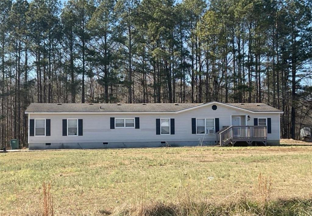 Wonderful opportunity in Gordon County! Nestled on a peaceful 2.02-acre lot, this inviting doublewide home offers the perfect blend of comfort and country charm. Featuring 3 bedrooms and 2 bathrooms, the layout provides plenty of space for relaxed living. Inside, you’ll find a warm and welcoming atmosphere—ideal for unwinding after a busy day. Step outside and enjoy the serene country road setting, where tranquility is part of everyday life. The expansive, level yard is well-maintained and ready for your vision—whether that’s a flourishing garden, family gatherings, or simply soaking in the open space. Recent updates, including a brand-new roof, add to the home’s appeal. With open land available, you also have the option to build an outbuilding for storage, a workshop, or your next creative project. This home offers the perfect combination of indoor comfort and outdoor freedom—making your dream of country living a reality. Schedule your visit today and explore the endless possibilities!
